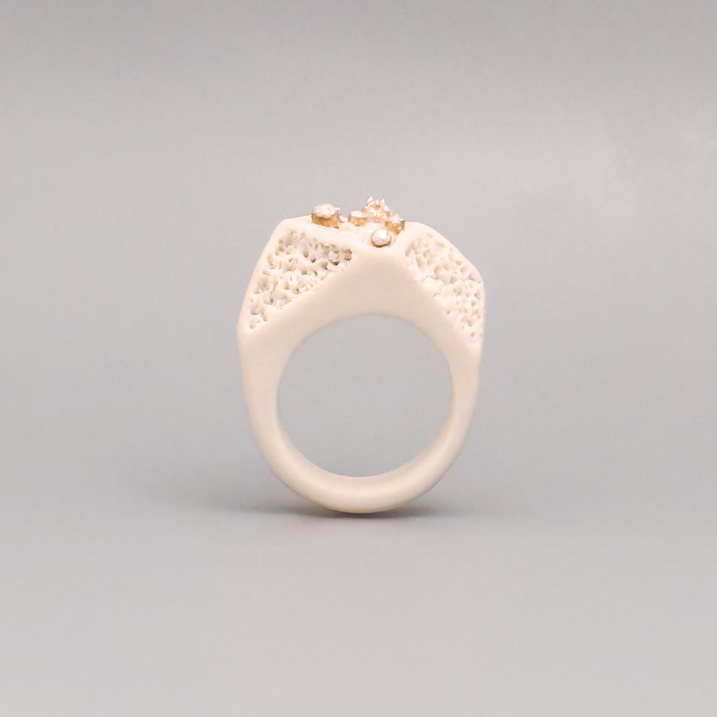 Front view of handmade porcelain ring with melted silver detail inspired by Mediterranean coral reefs