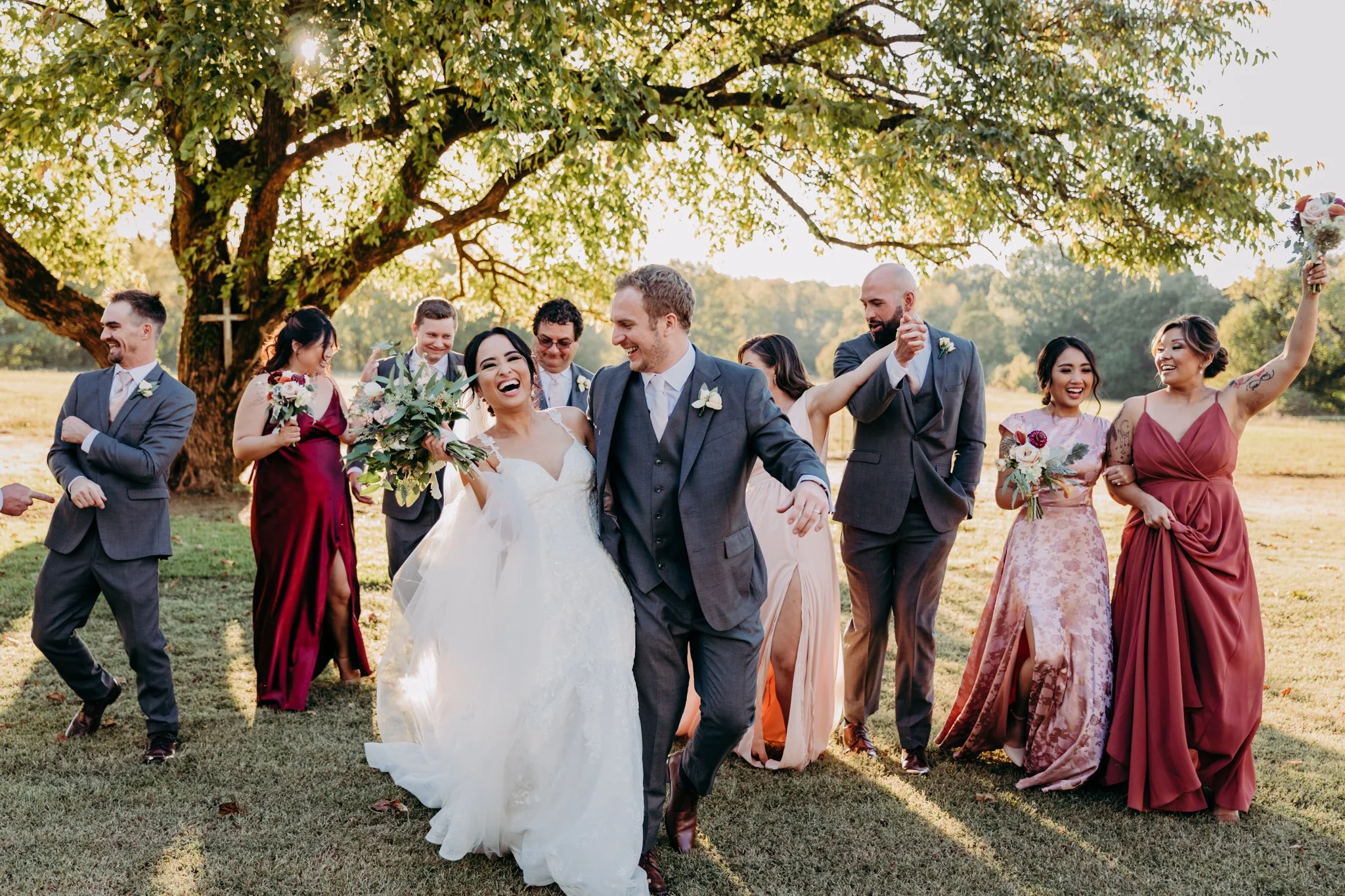 Fall Wedding Party at Hedge Farms laughs during sunset