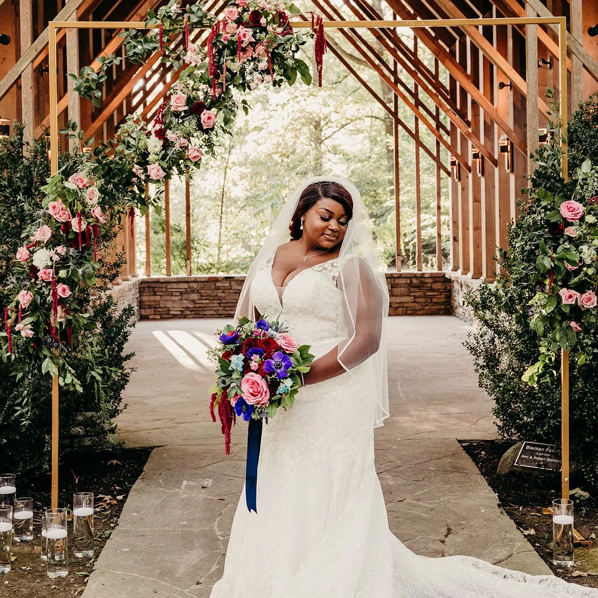 Bride poses in front of Floral Chapel at Memphis Botanic Gardens