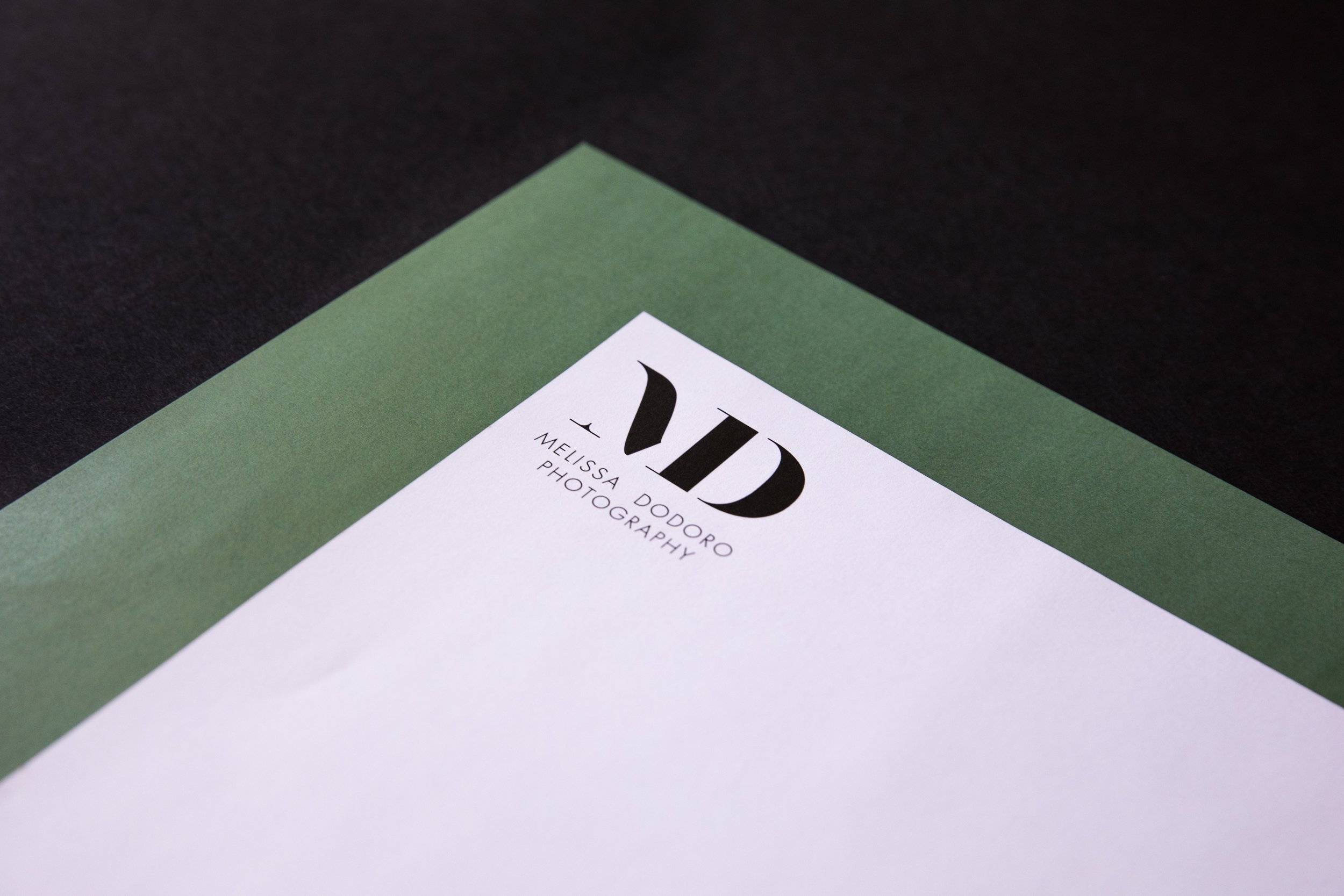 Detail of the primary logo on business paper designed for Melissa Dodoro Photography