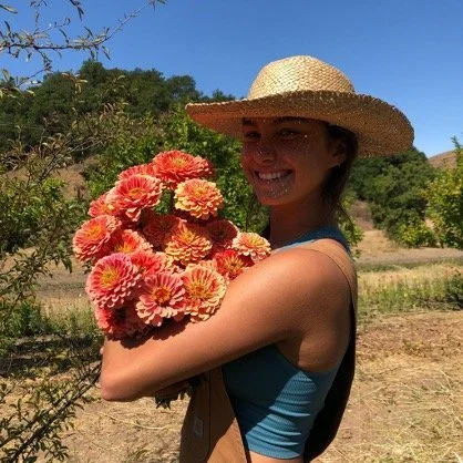 Lilja working on the farm, harvesting zinnias. Photo - Courtney Mellblom