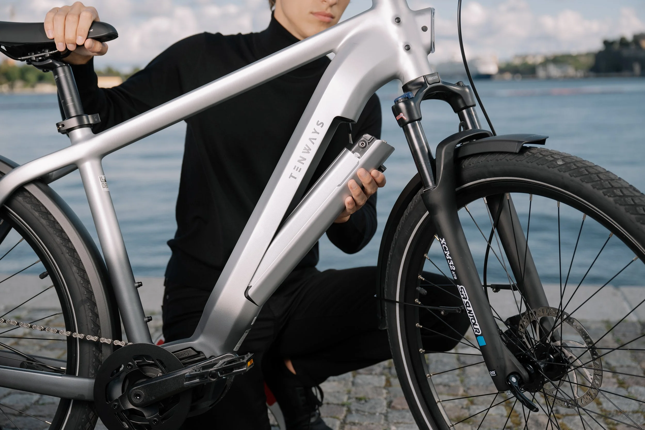 Person removing the battery from a Tenways electric bike. - Commercial photography in Stockholm by Film8