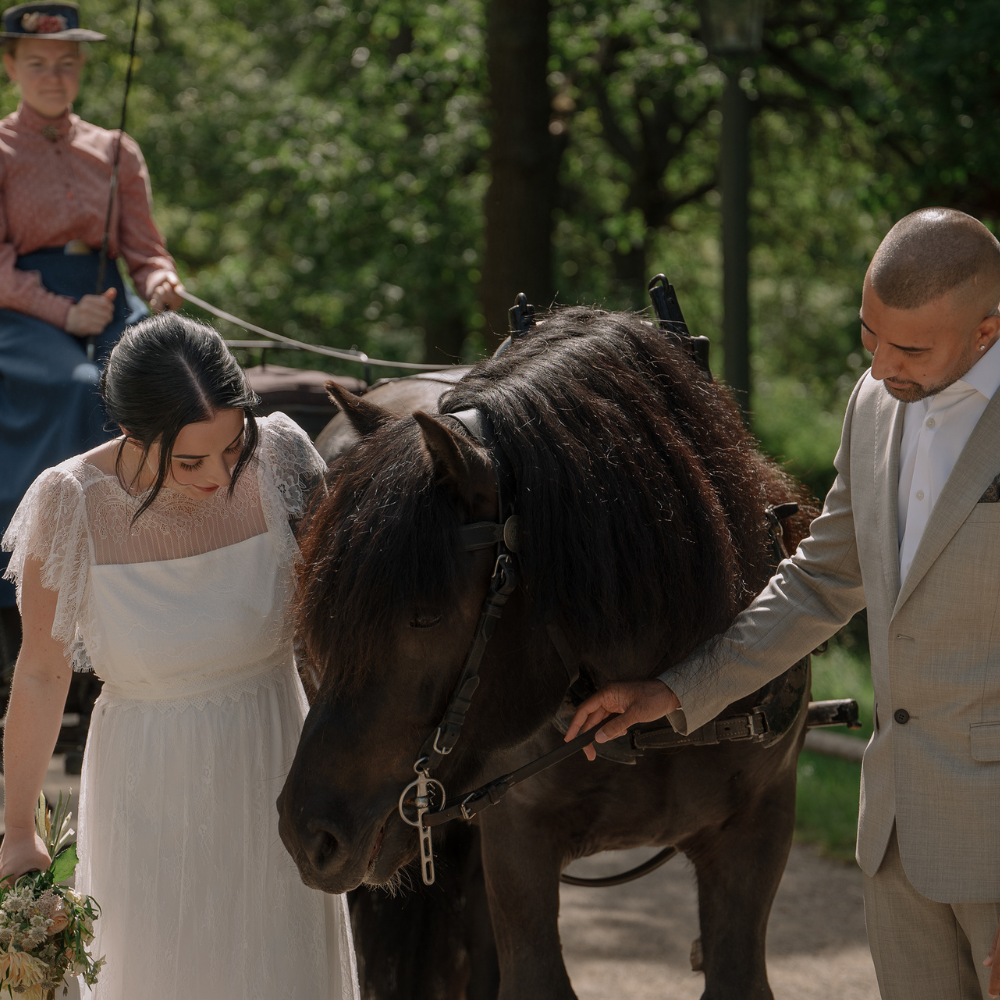 Bride and groom with a pony during an outdoor wedding in Sweden