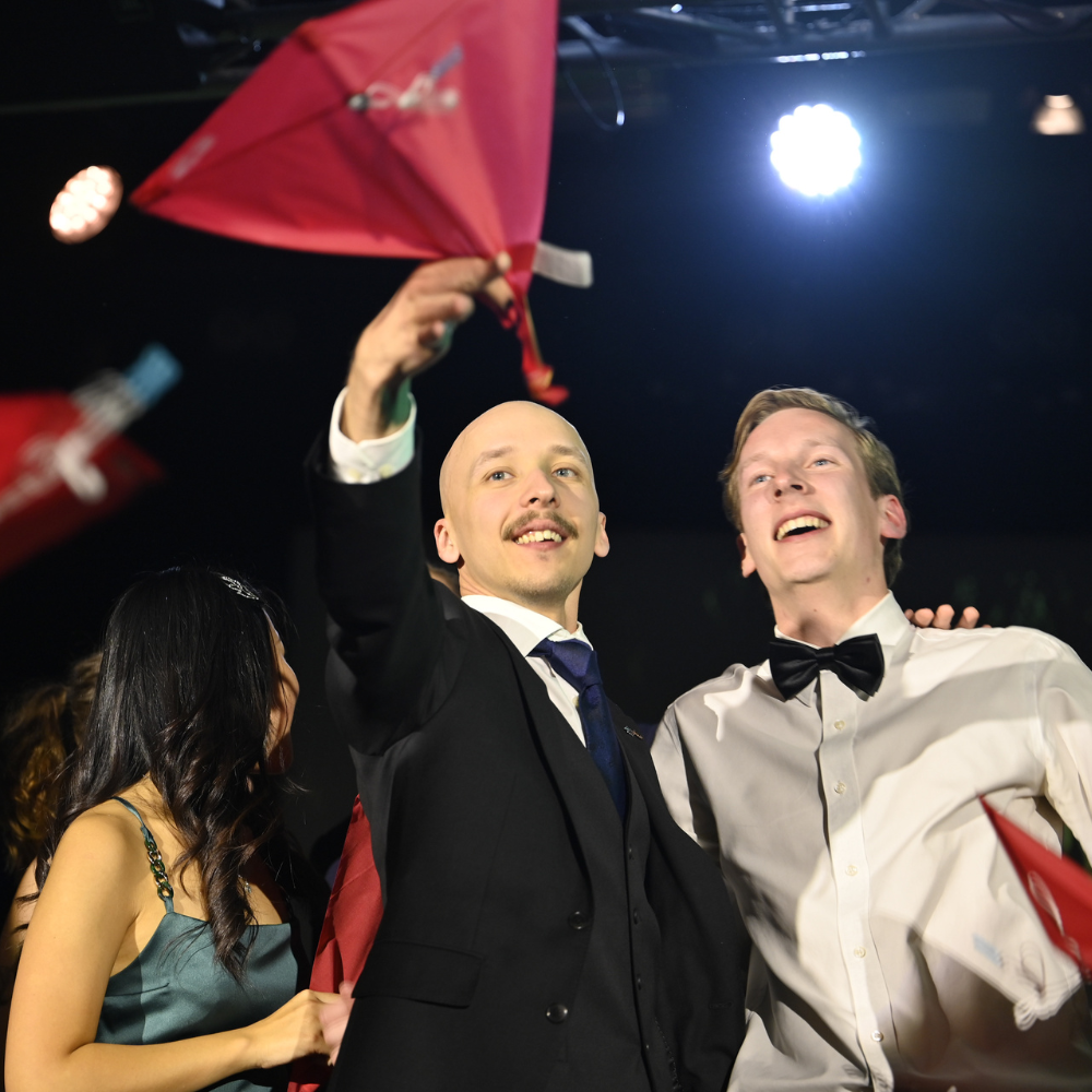 Guests celebrating under stage lights during the DKP welcoming event in Stockholm