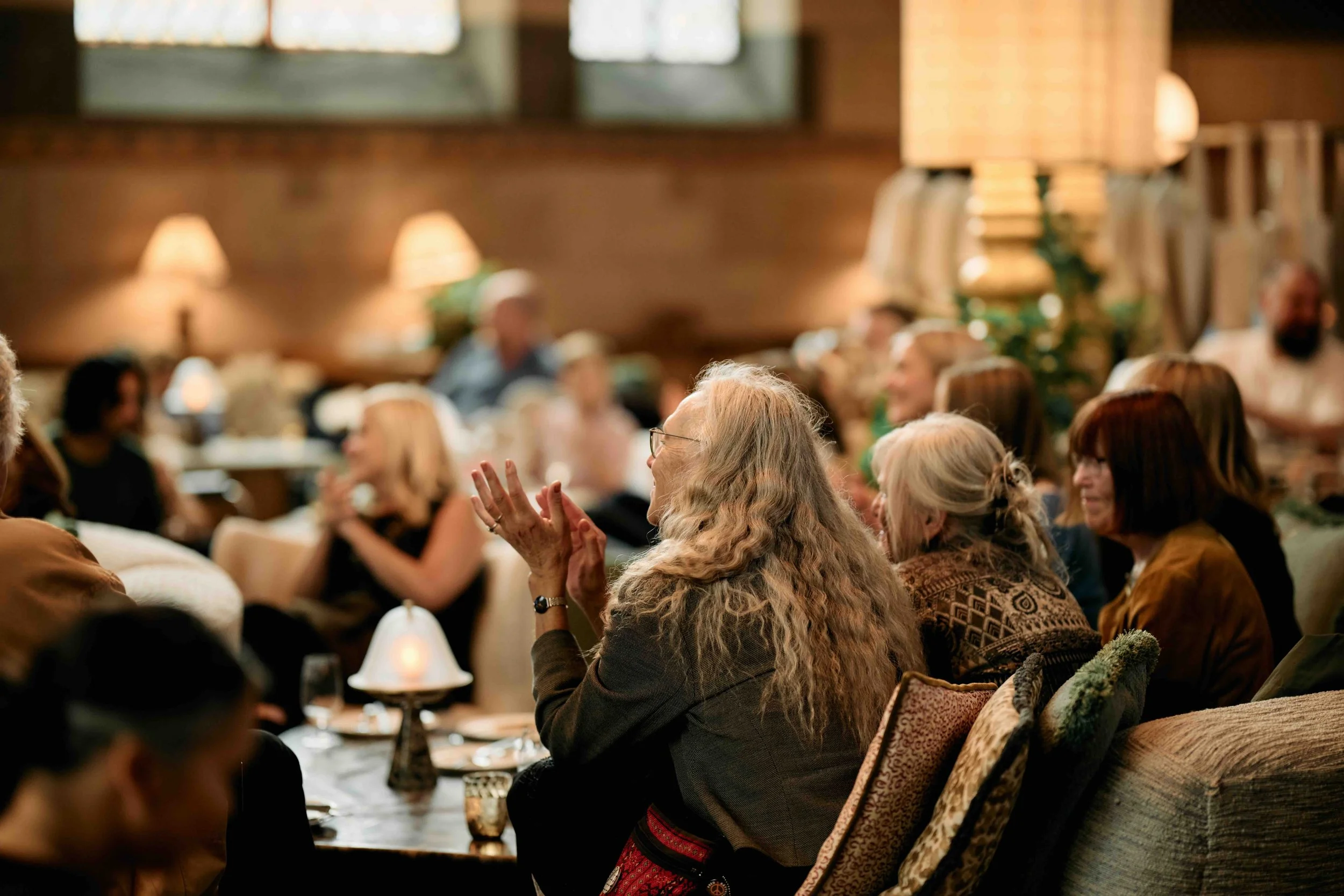 Audience members listening and reacting during the Stripey Bear book launch event at Soho in Stockholm.