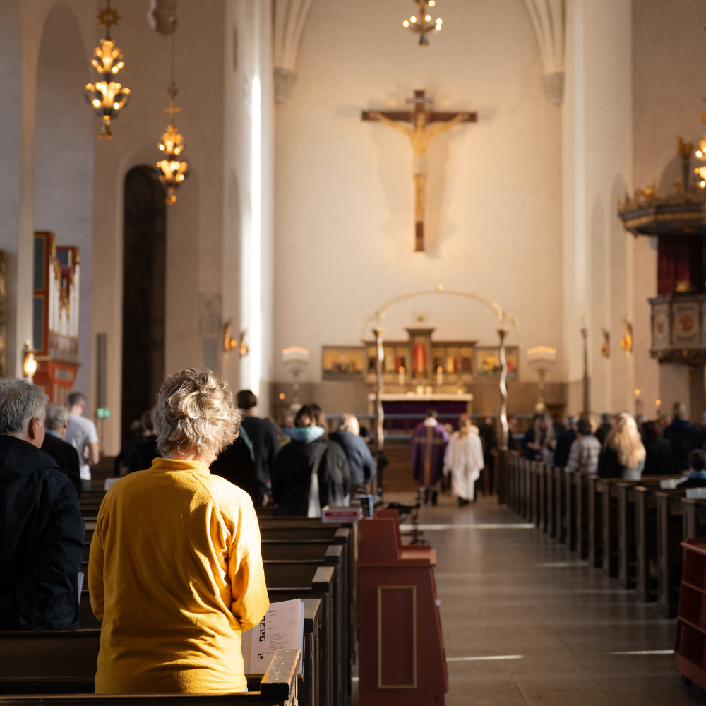 Worshippers walking through the nave during a service at Högalidskyrkan