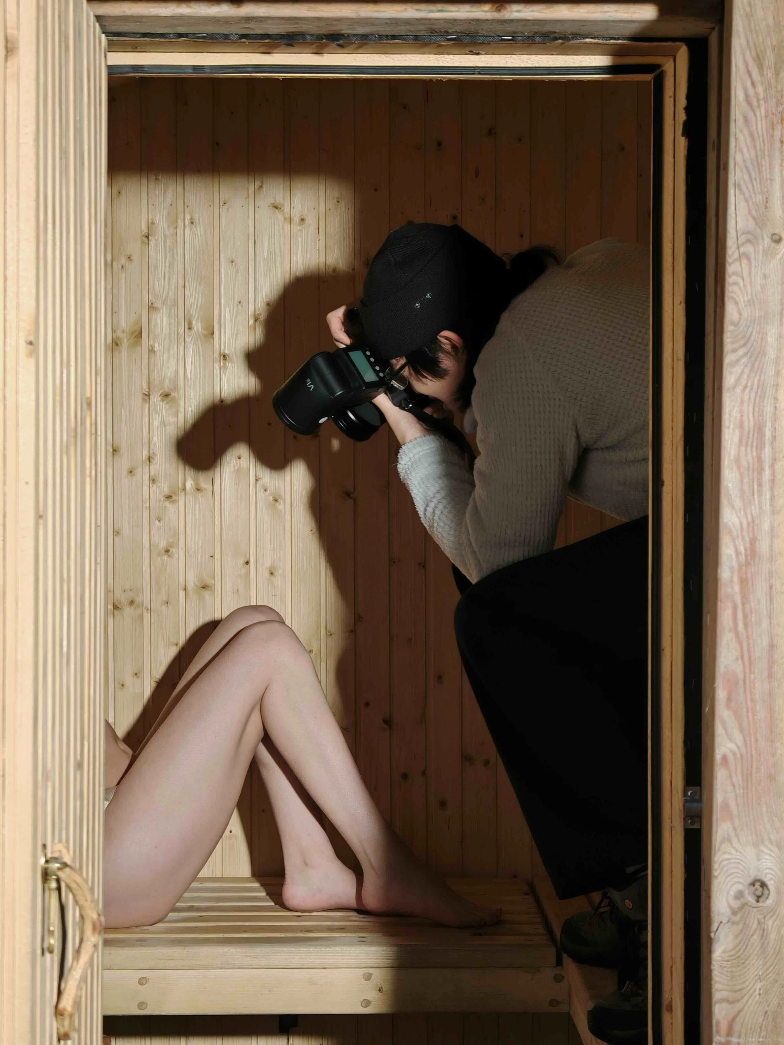 Photographer shooting the MÅNELLA lingerie campaign inside a Swedish cabin