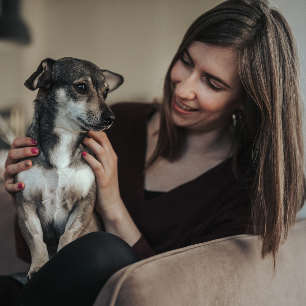 Dog and owner photographed together indoors