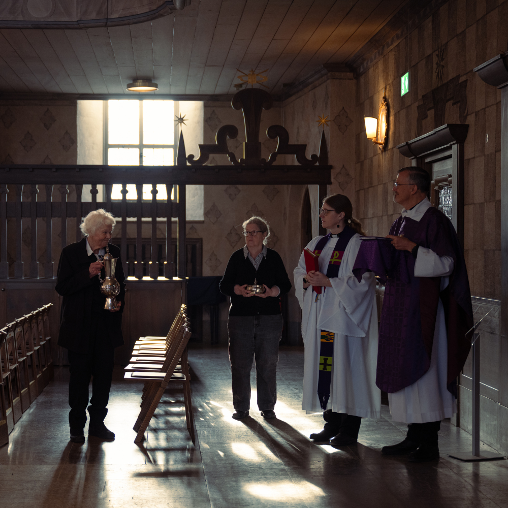 Clergy and volunteers standing in a side chapel at Högalidskyrkan