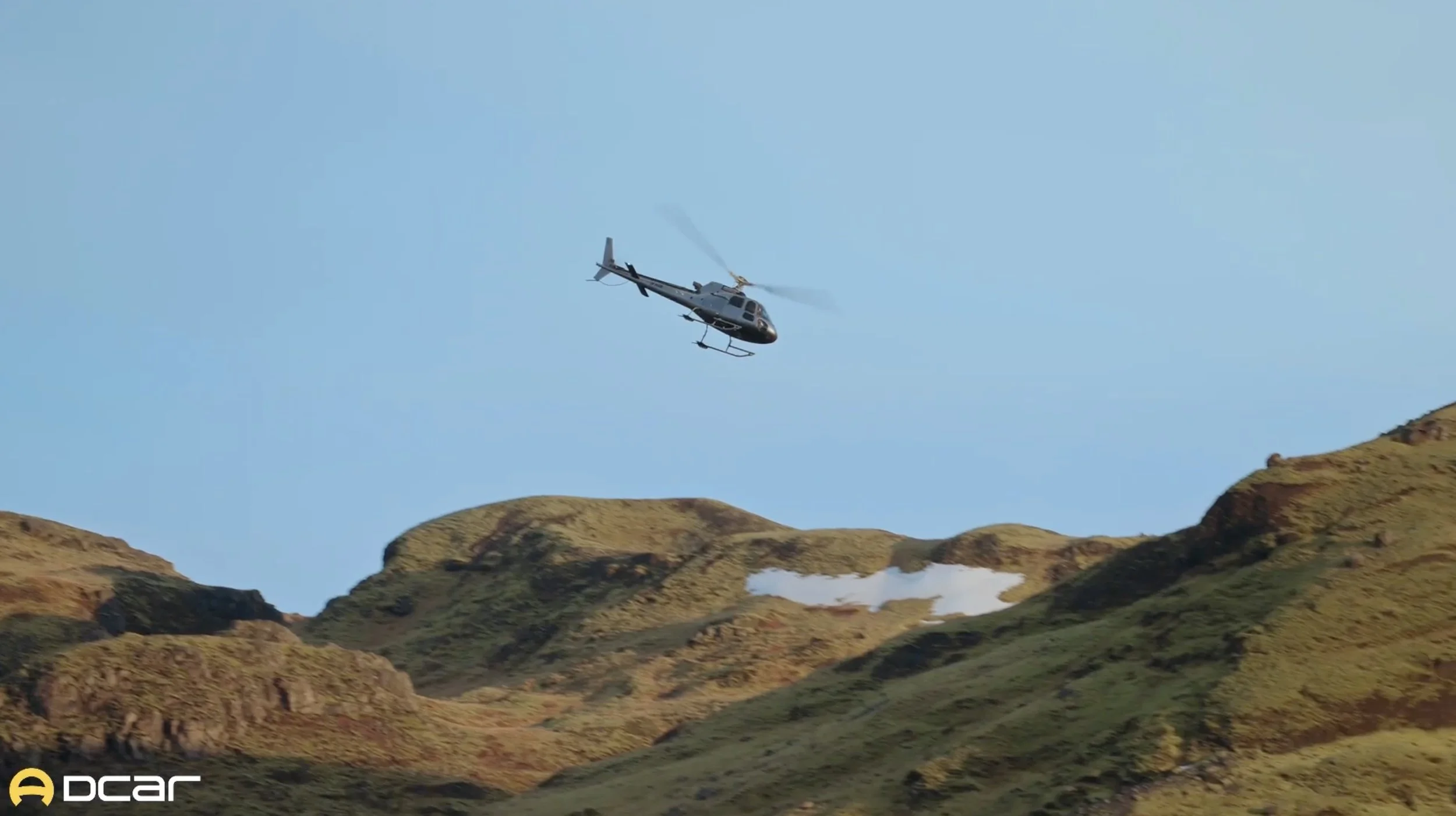 Helicopter flying over the mountains during an automotive production in Iceland