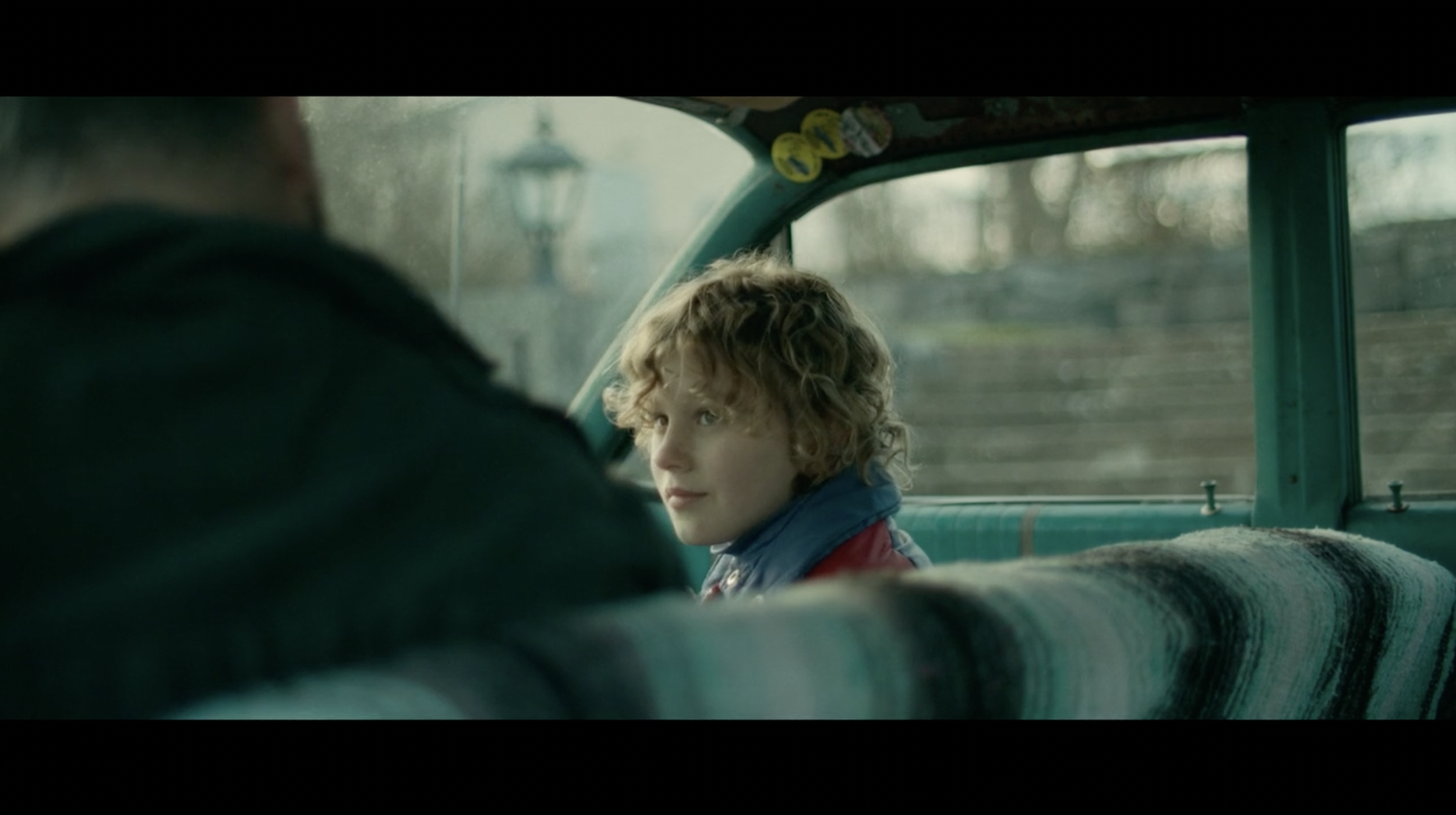 Cinematic still of a child inside a car from a film photographed by Wilma Wickström
