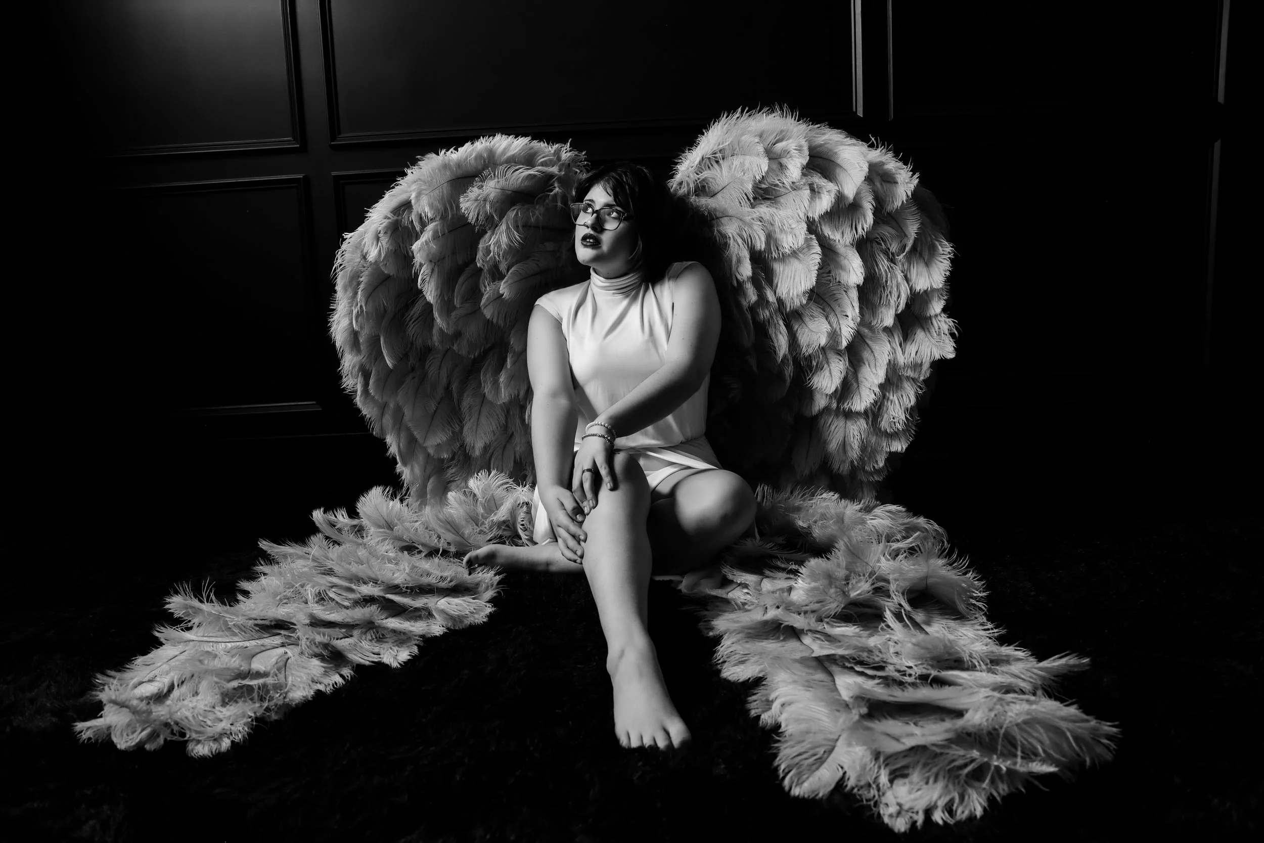 Fine art senior portrait of a teenage girl with glasses wearing angel wings in Phoenix