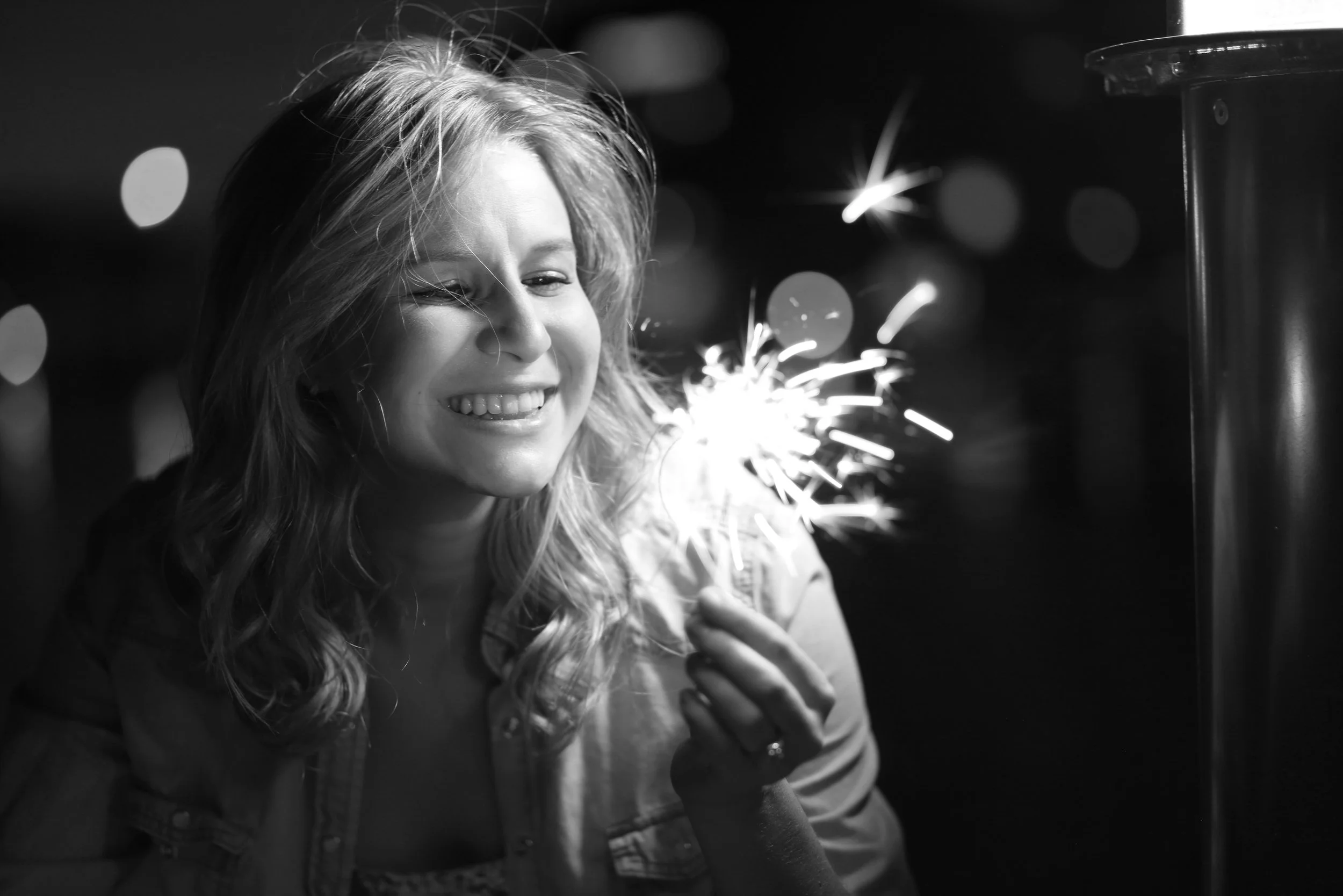 Female college senior portrait in Phoenix with night time fireworks