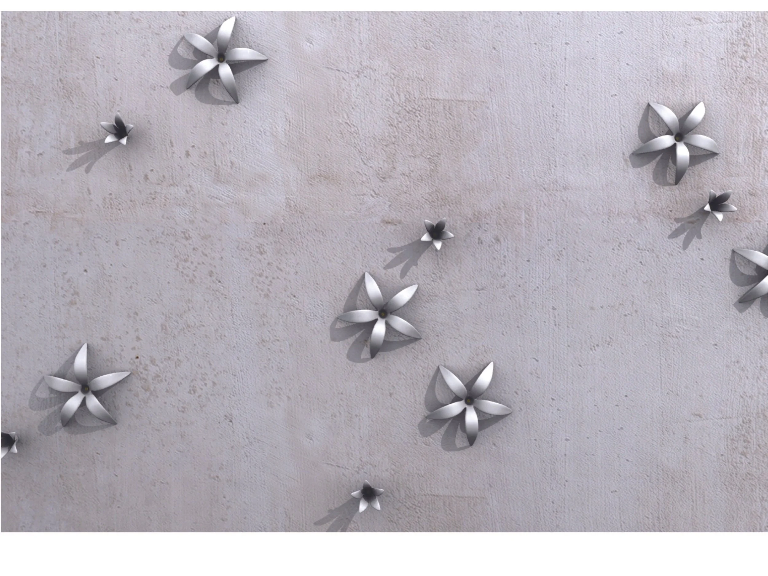 Several white paper or metallic flowers with shadows on a textured, light-colored wall.