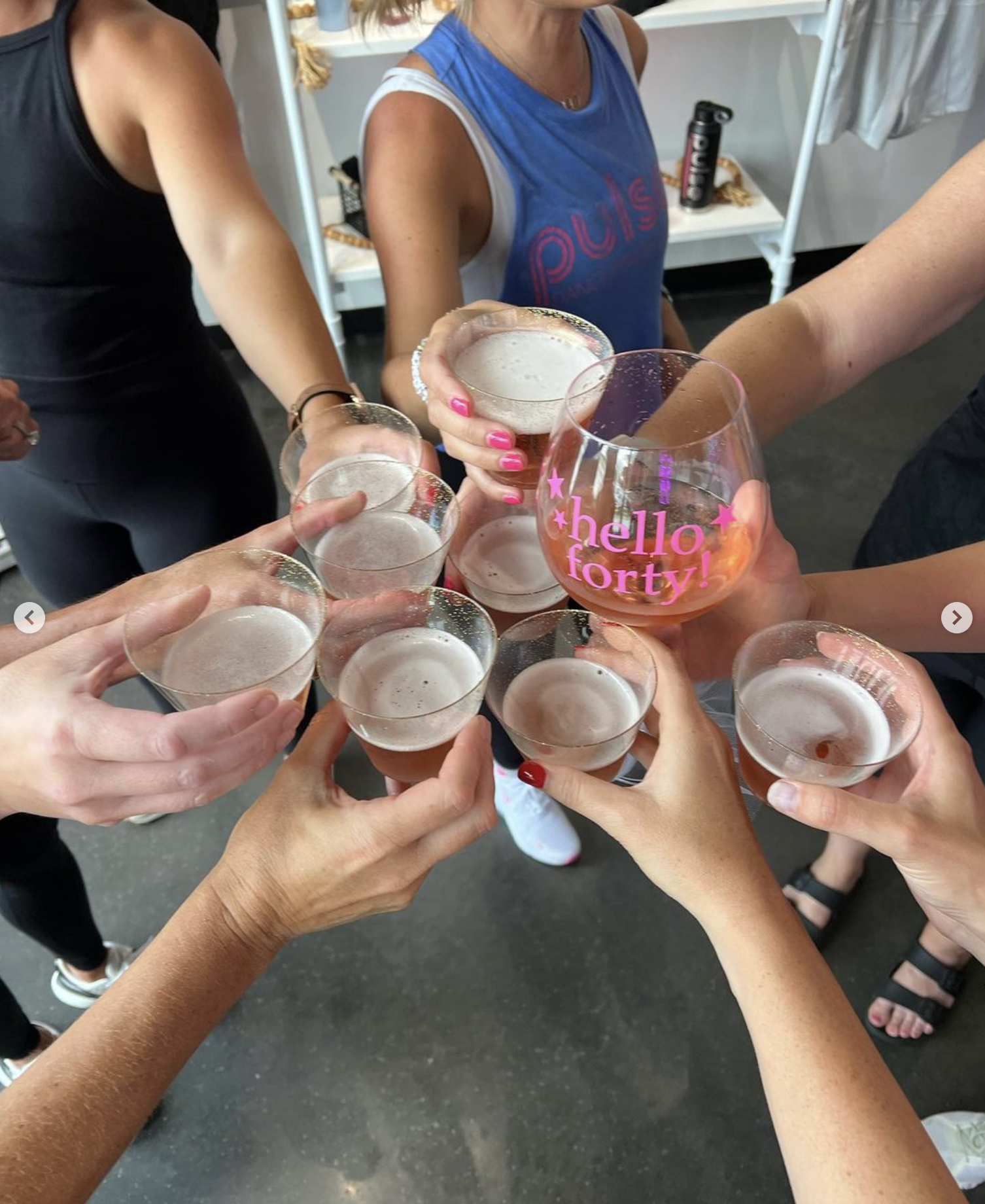 Women celebrating a 40th birthday party with champagne at Pulse Dance Fitness Studio in Des Moines Iowa