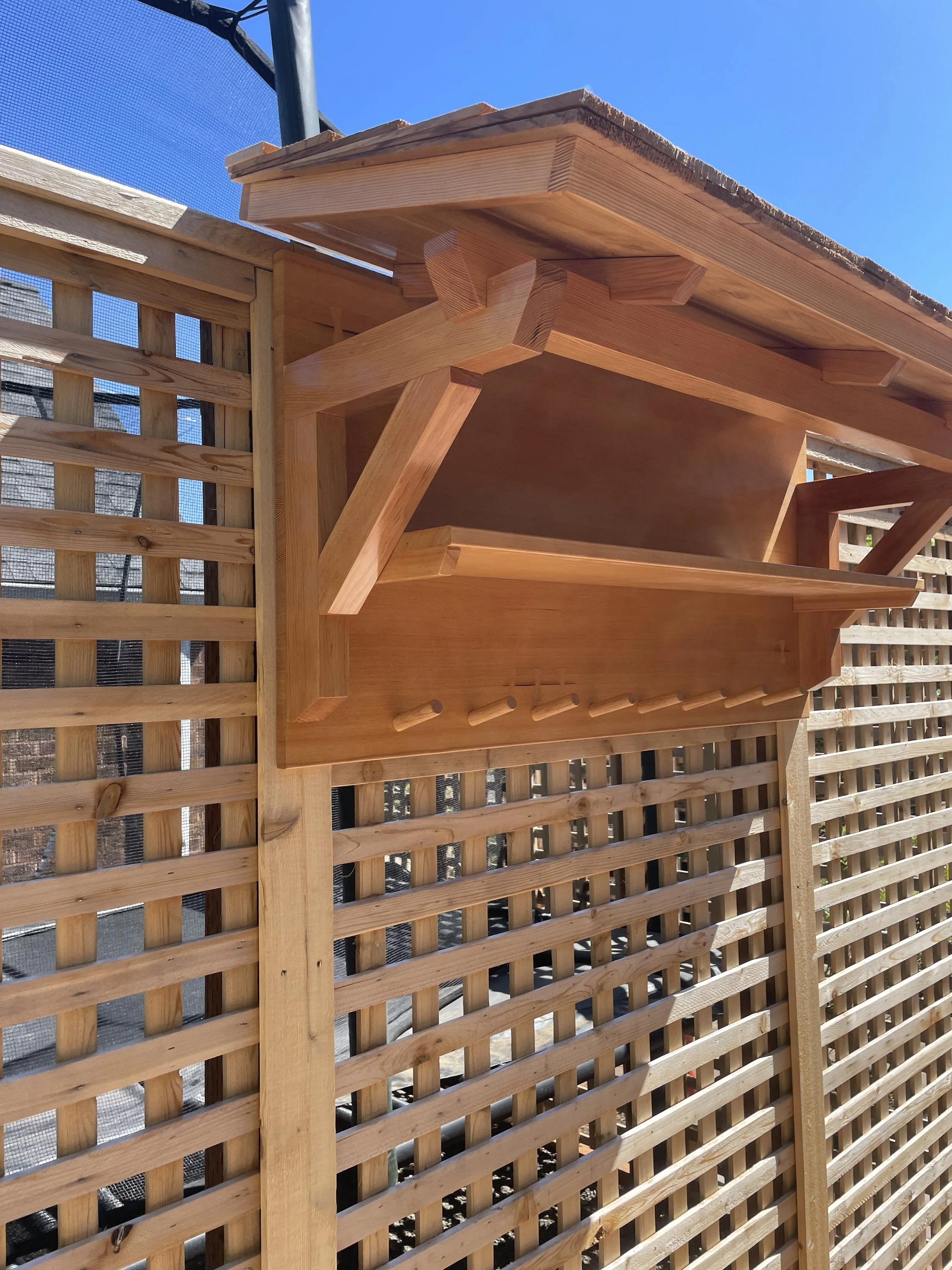 Outdoor covered towel rack and shelf for hot tub.