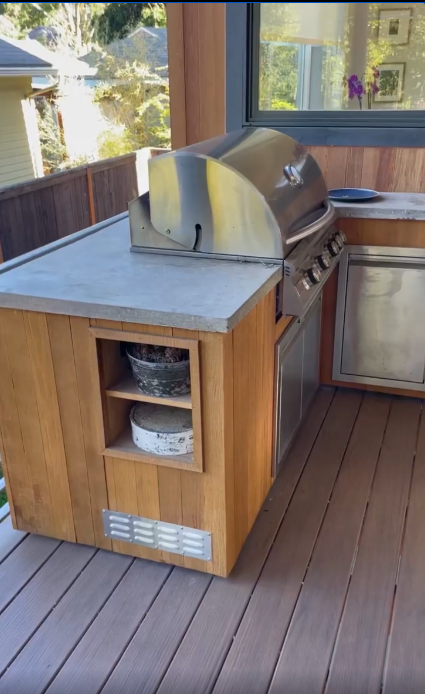 Built in outdoor grill station with concrete countertops.