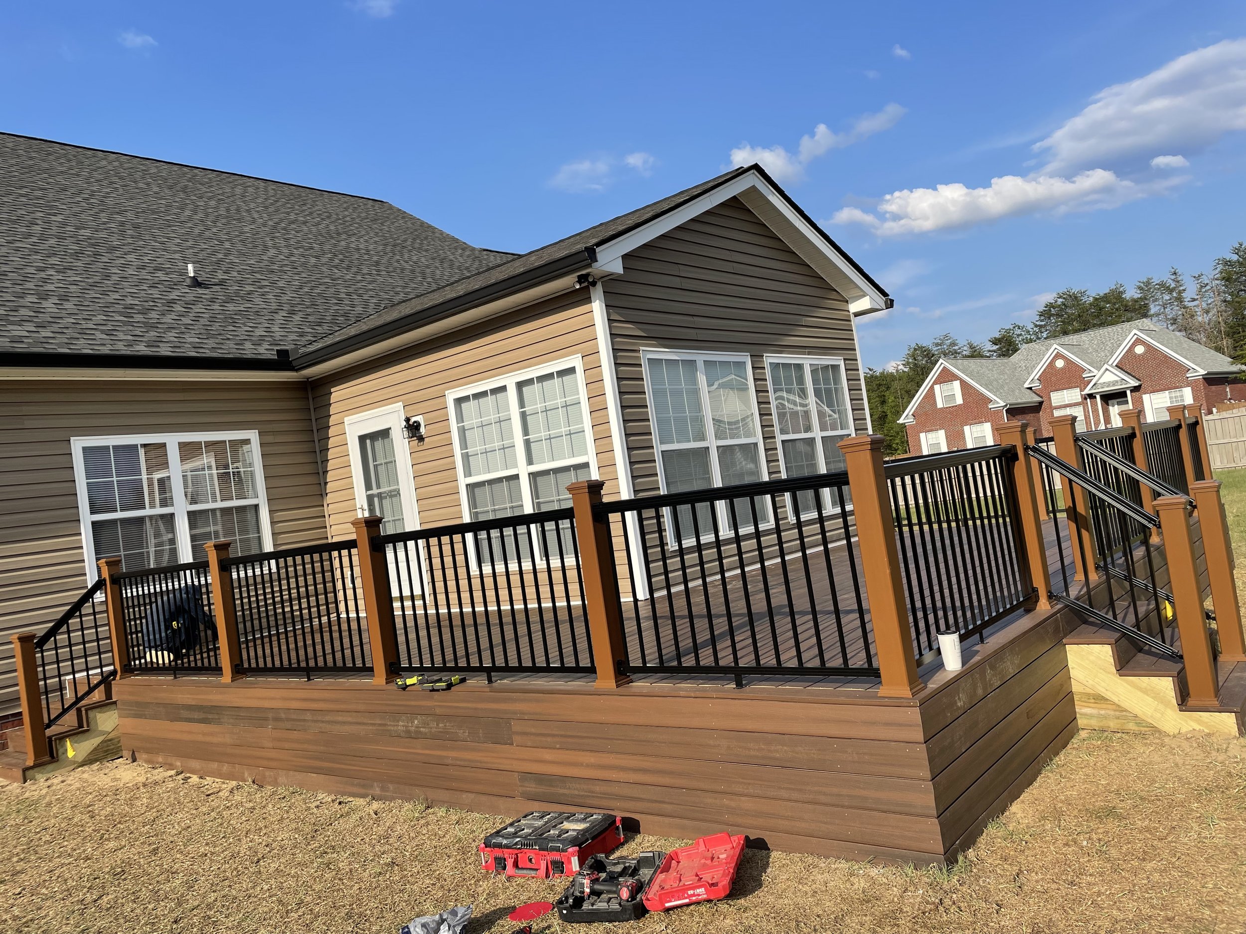 after photo of trex deck wraparound porch build with black railing