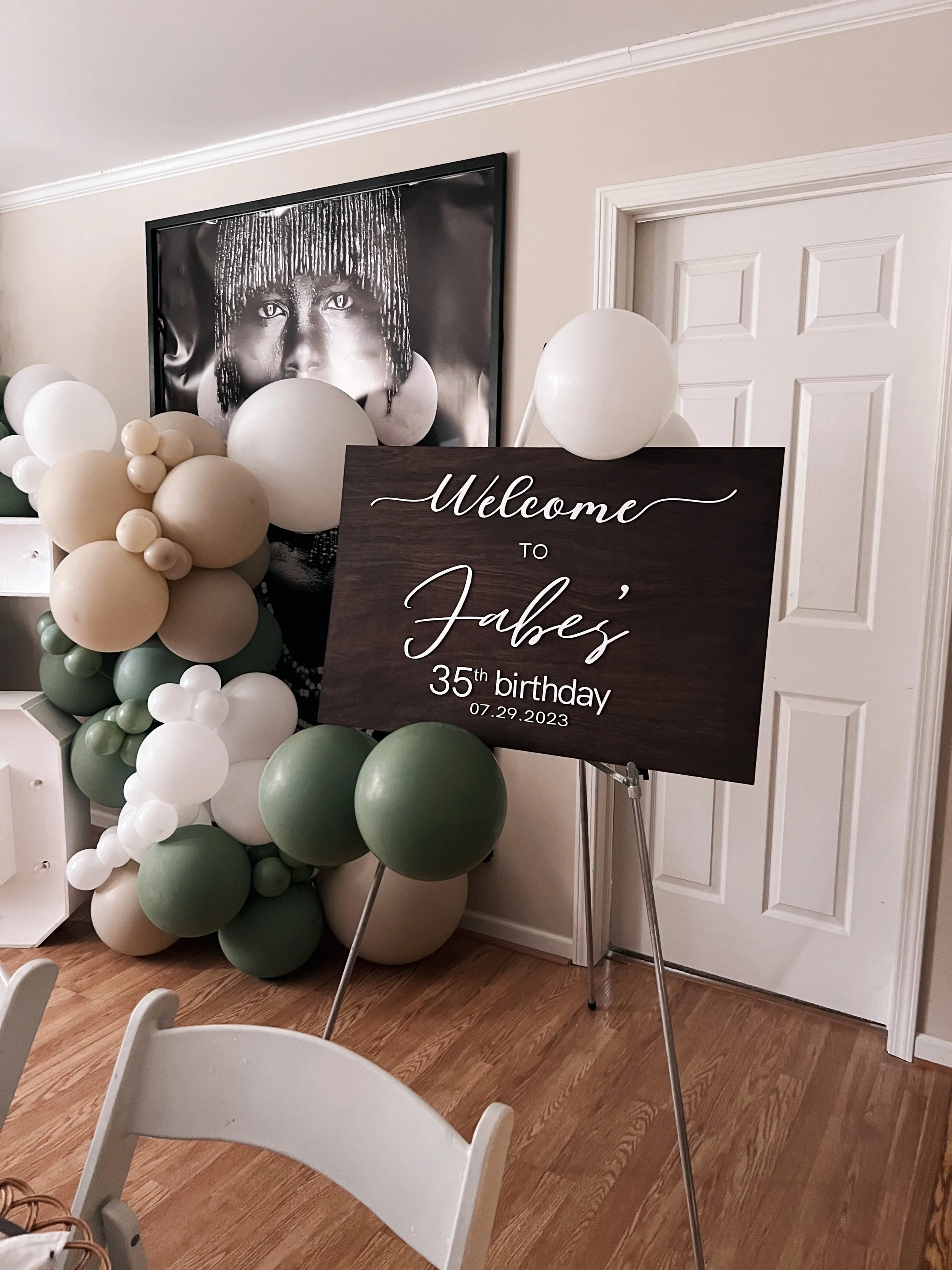 Customizable wooden sign sitting on ottoman beside wooden picnic table designed by Picnics By Peace