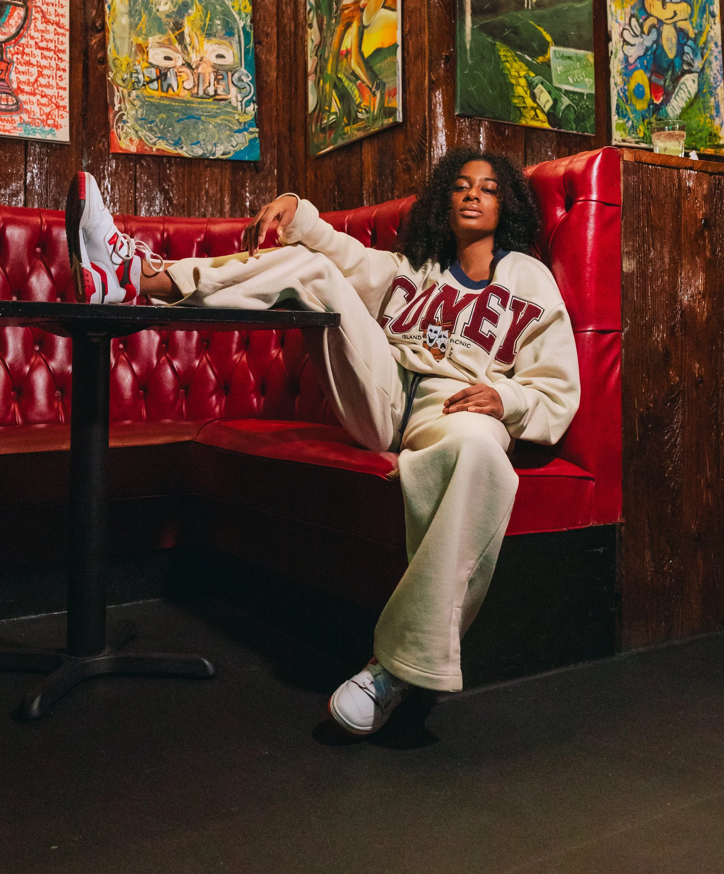 Candian actress, stuntwoman, and model, Amanda Whyte, seen posing in a red chair for a streetwear brand.