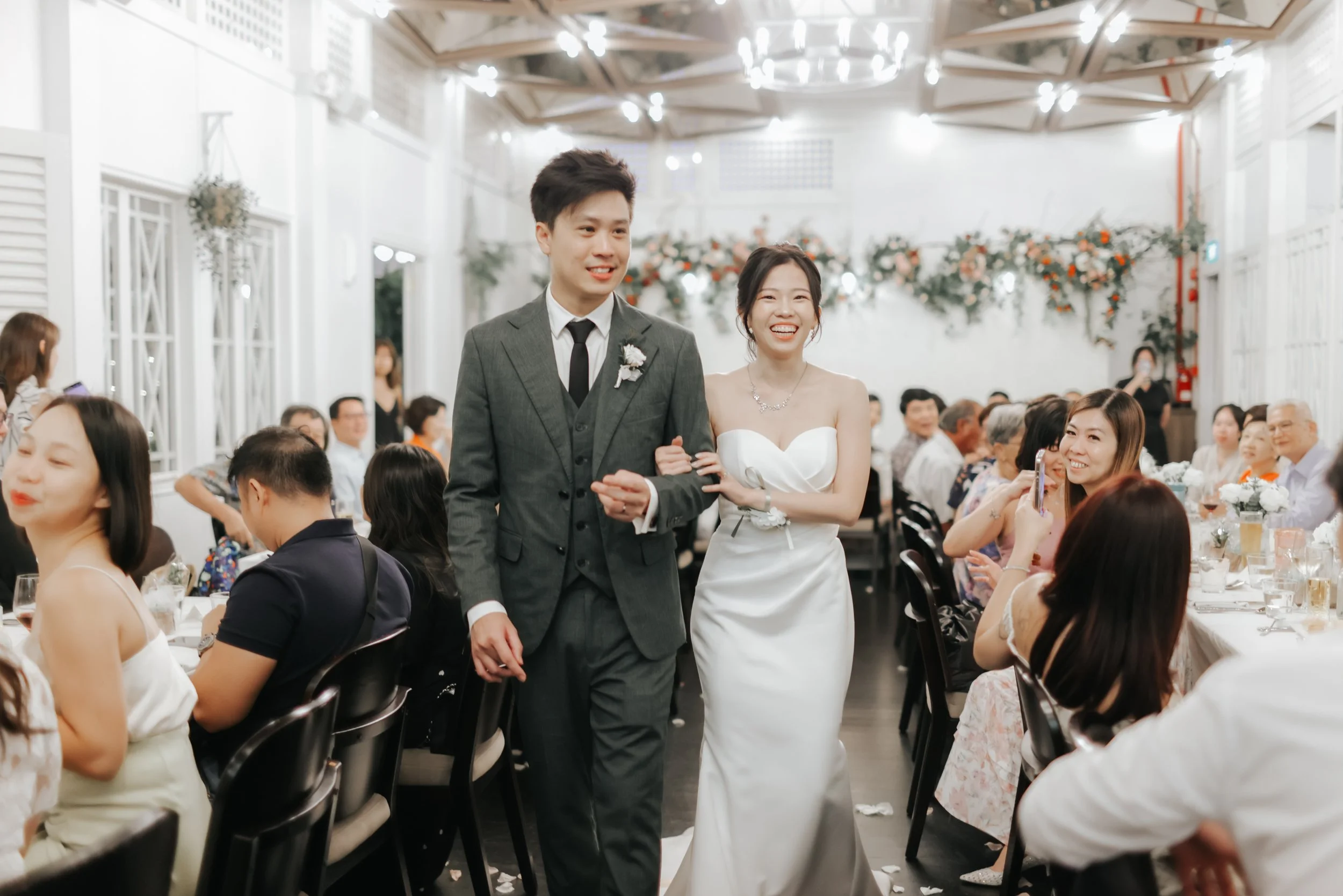 Light and airy actual day wedding photoshoot at the Summerhouse in Singapore of the couple walking down the wedding aisle. Captured by Arielle for Breadandbutterworks.