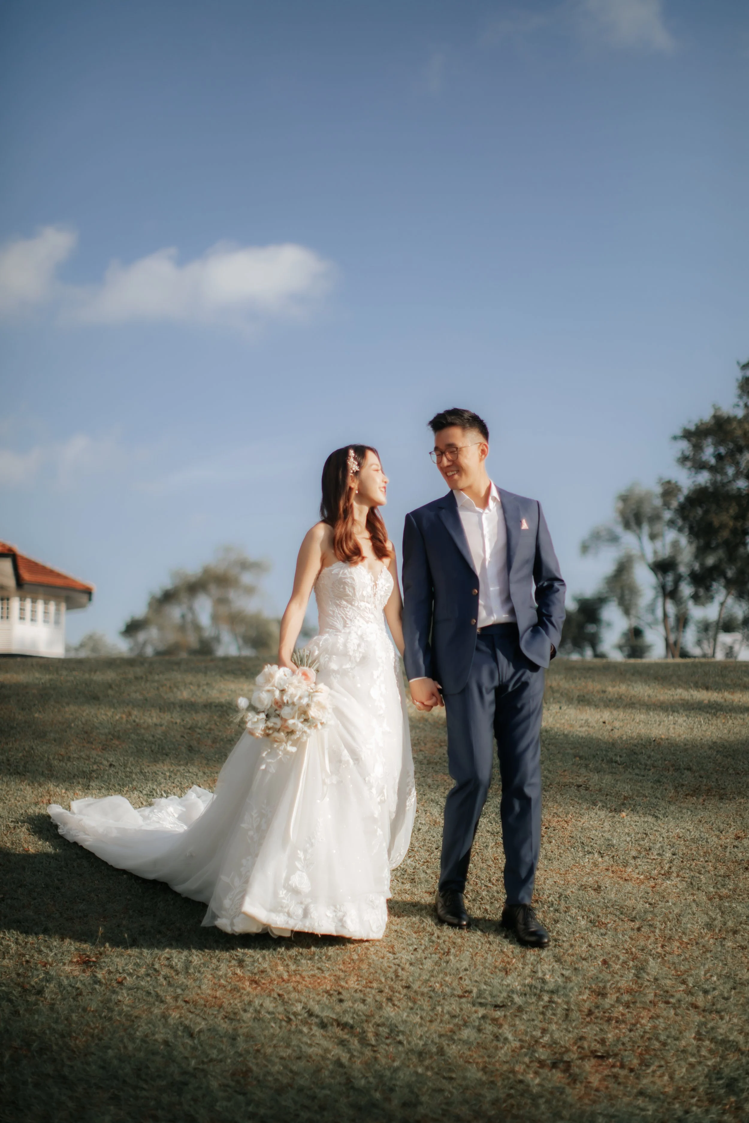 Light and airy pre-wedding photoshoot at Arwaa Mansion, featuring the couple taking a stroll on the lawn with the colonial architecture as the backdrop. Captured by Ash for Breadandbutterworks.