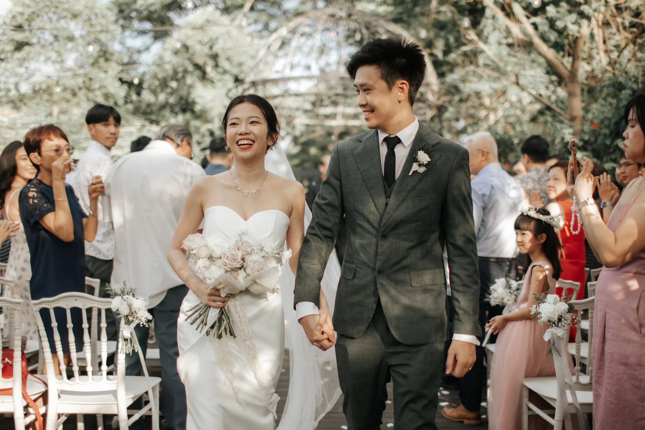 Light and airy actual day wedding photoshoot at the Summerhouse in Singapore of the couple walking down the wedding aisle. Captured by Arielle for Breadandbutterworks.