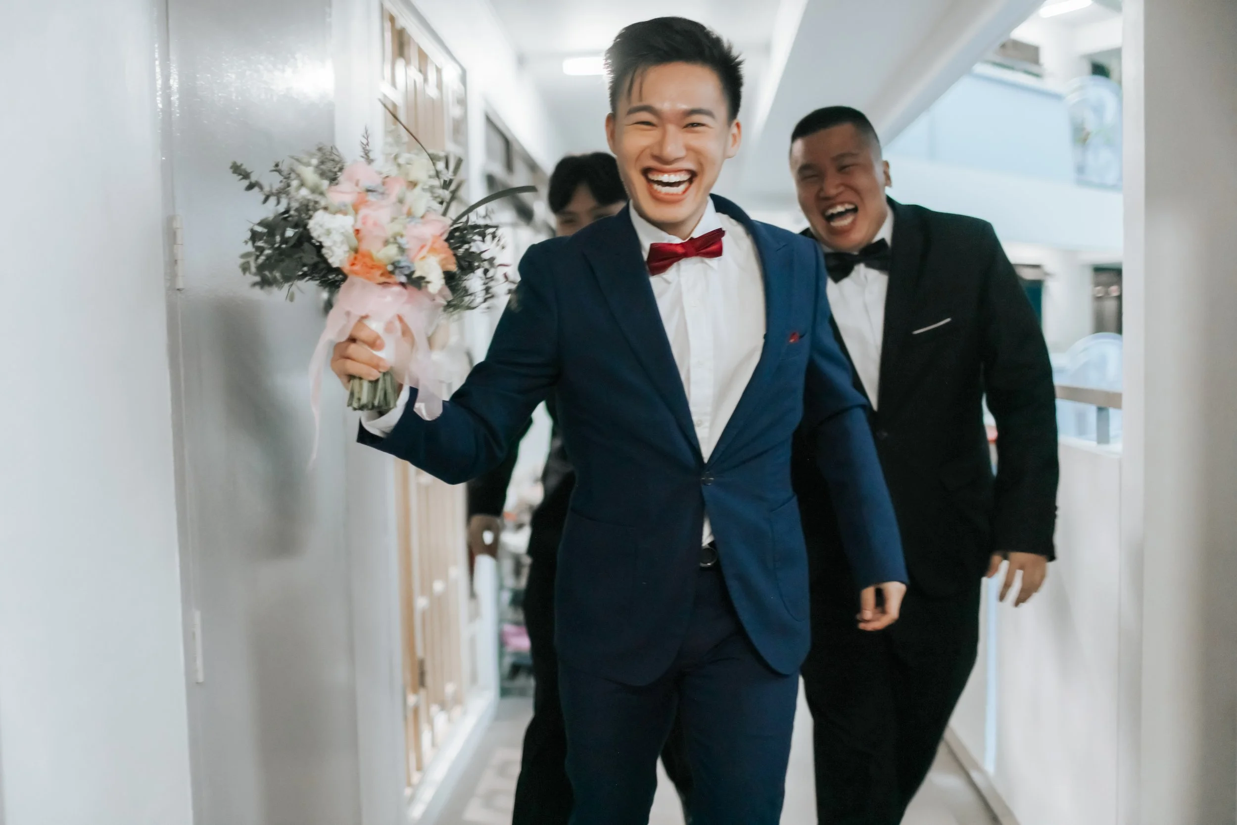 A groom on his actual wedding day on his way to pick up his bride. He is beaming from ear to ear with his groomsmen in tow, equally cheerful. Captured in a light and airy style by Arielle for Breadandbutterworks.