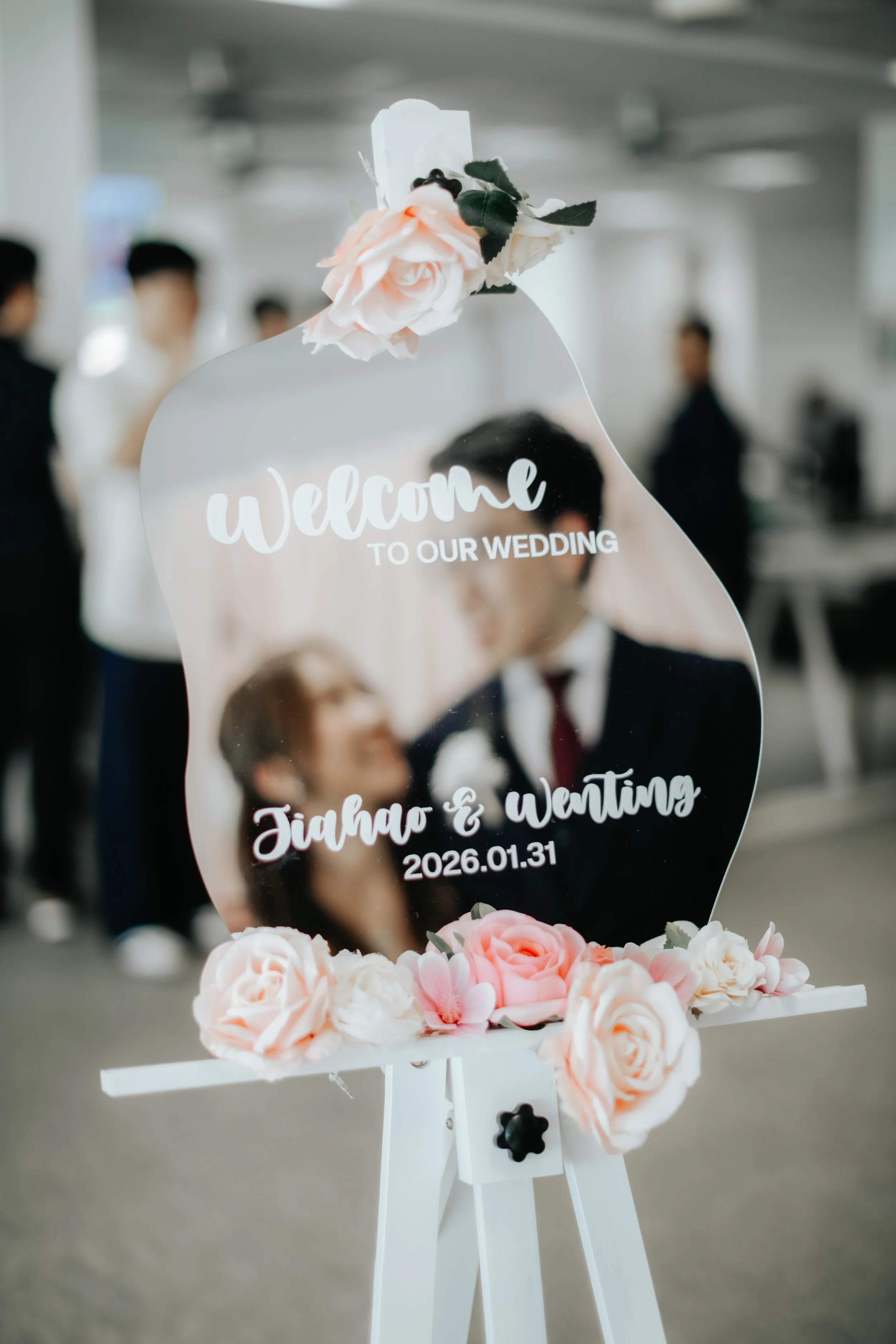 Artistic, light and airy mirror shot from a actual day photoshoot of a couple at Bukit Panjang Church, the photo focuses on the text on the mirror with the silhouette of the couple in bokeh in the background. Captured by Arielle for Breadandbutterwor