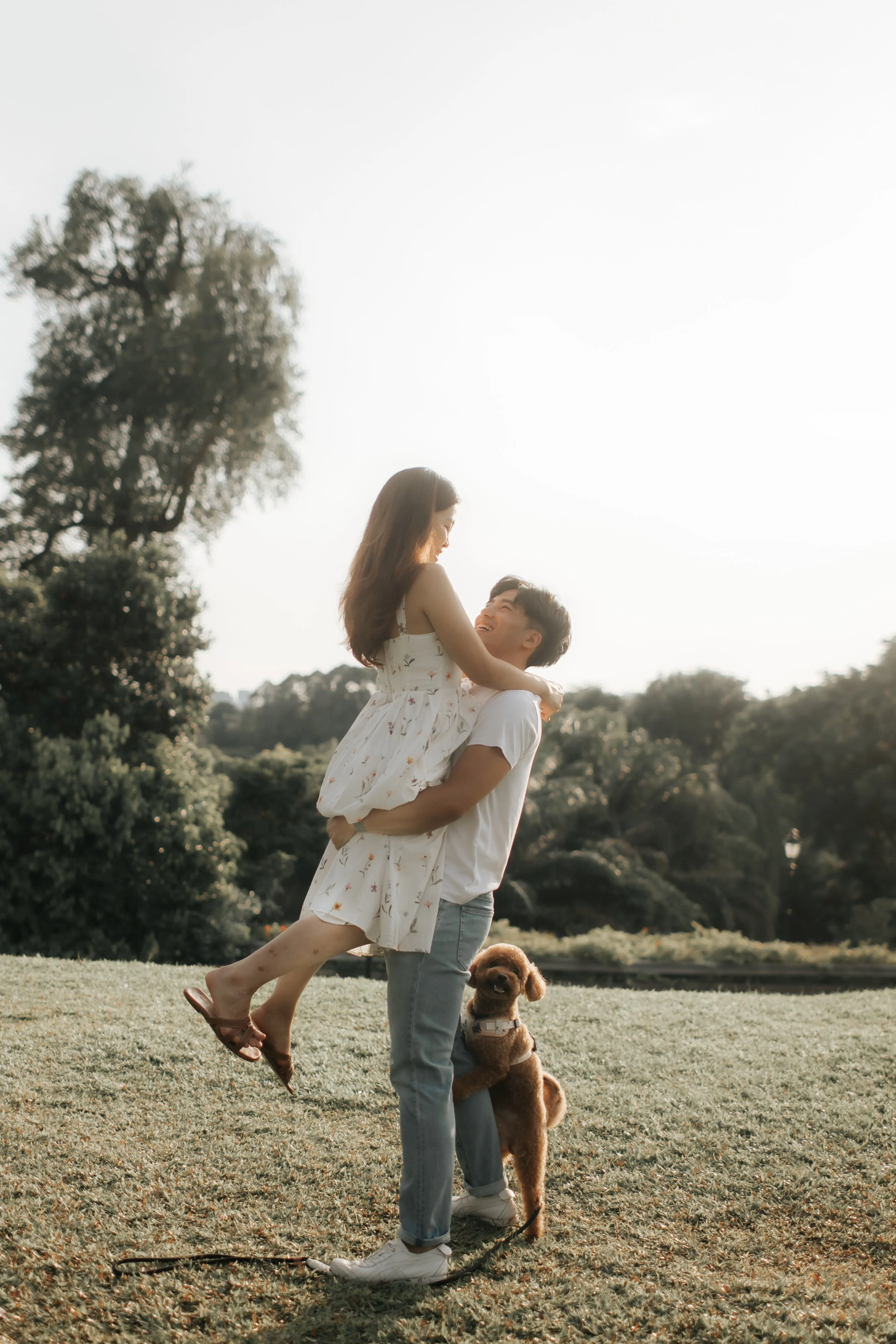 Light and airy pre-wedding photoshoot with pet dog on the field at Gallop Extension. Captured by Breadandbutterworks.