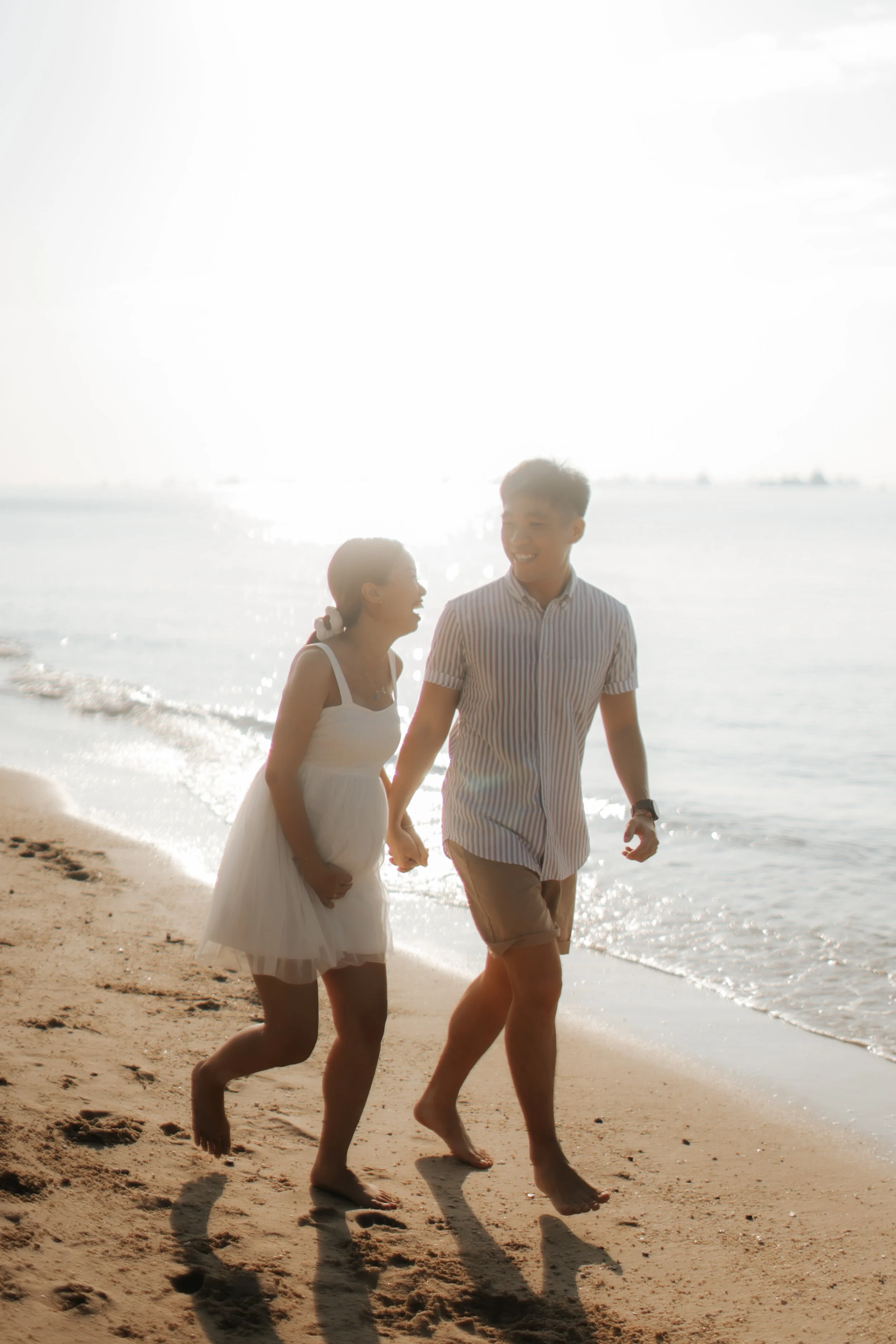 Light and airy maternity beach photoshoot at East Coast Park with a pet dog, captured by Arielle for Breadandbutterworks.