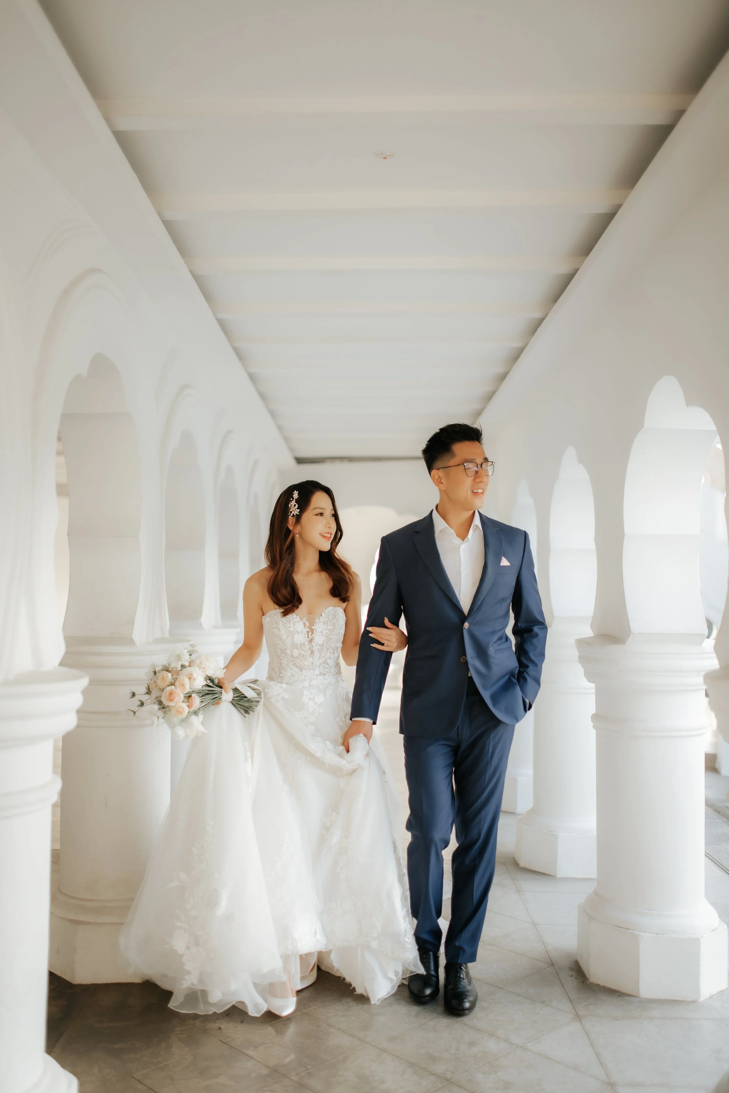 Light and airy pre-wedding photoshoot at Arwaa Mansion, featuring the couple strolling within the colonial architecture. Captured by Ash for Breadandbutterworks.