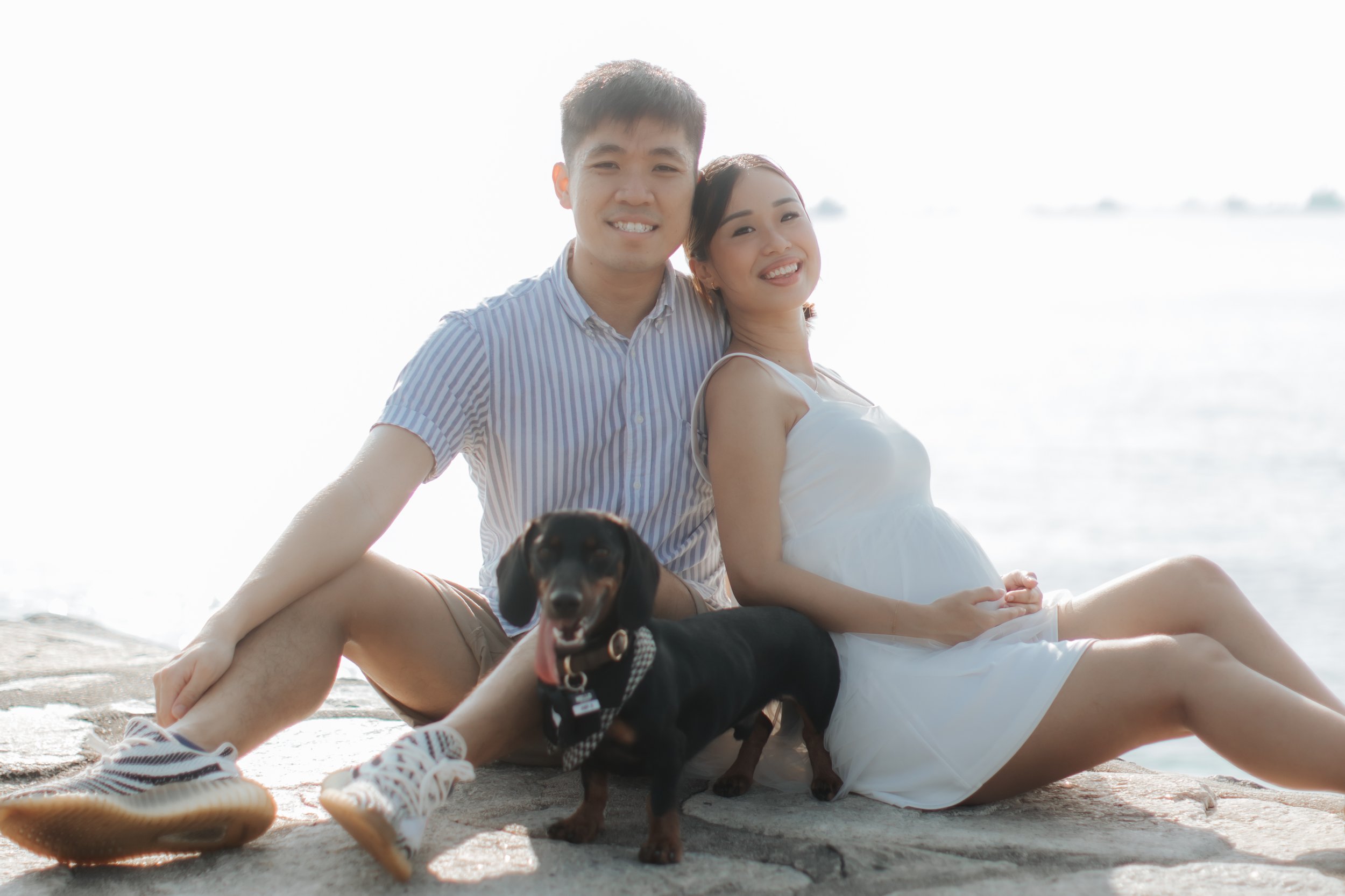 Light and airy maternity beach photoshoot at East Coast Park with a pet dog, captured by Arielle for Breadandbutterworks.