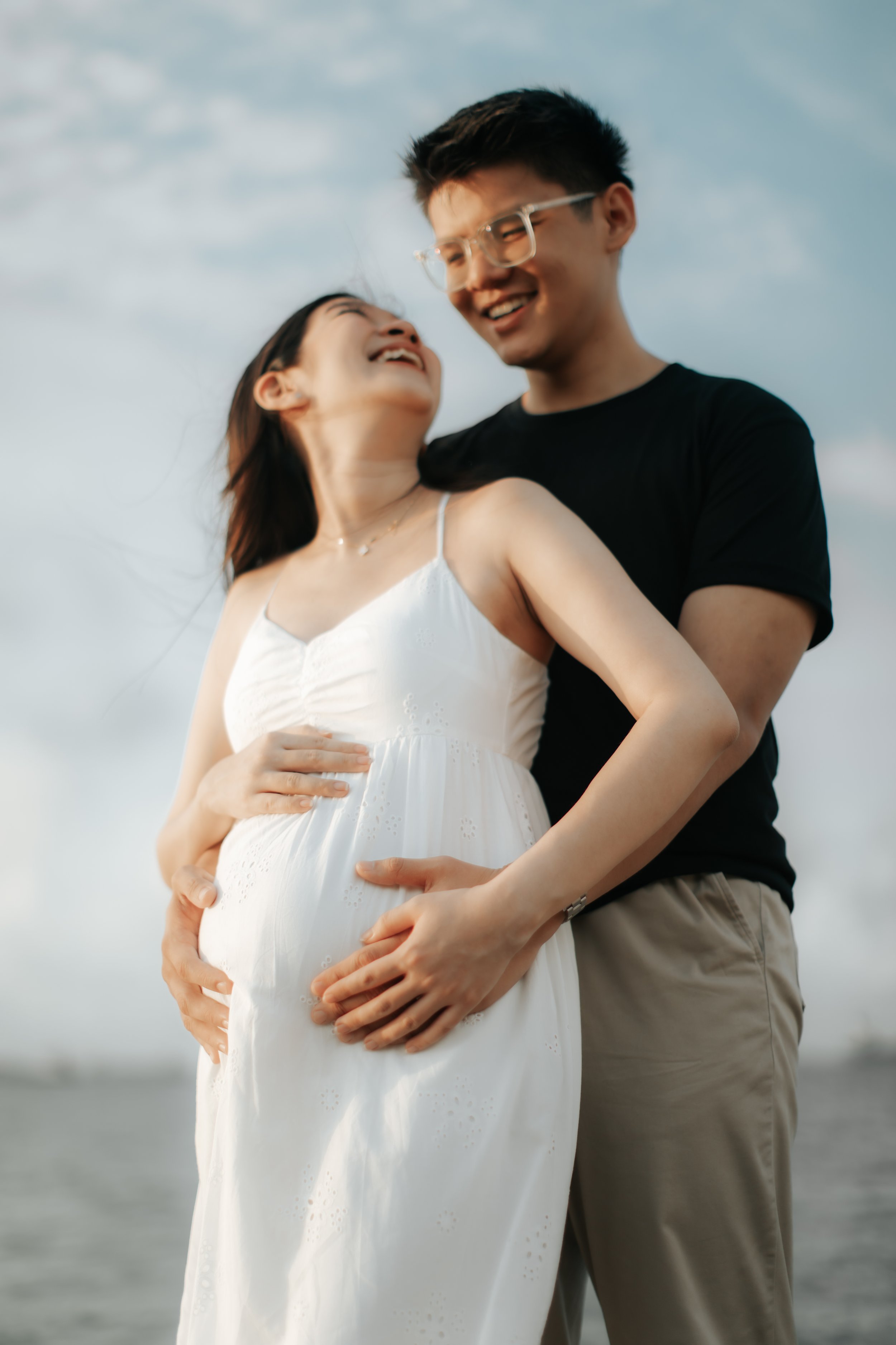 Intimate maternity shoot at sunset at East Coast Park in Singapore, captured by Arielle for Breadandbutterworks.