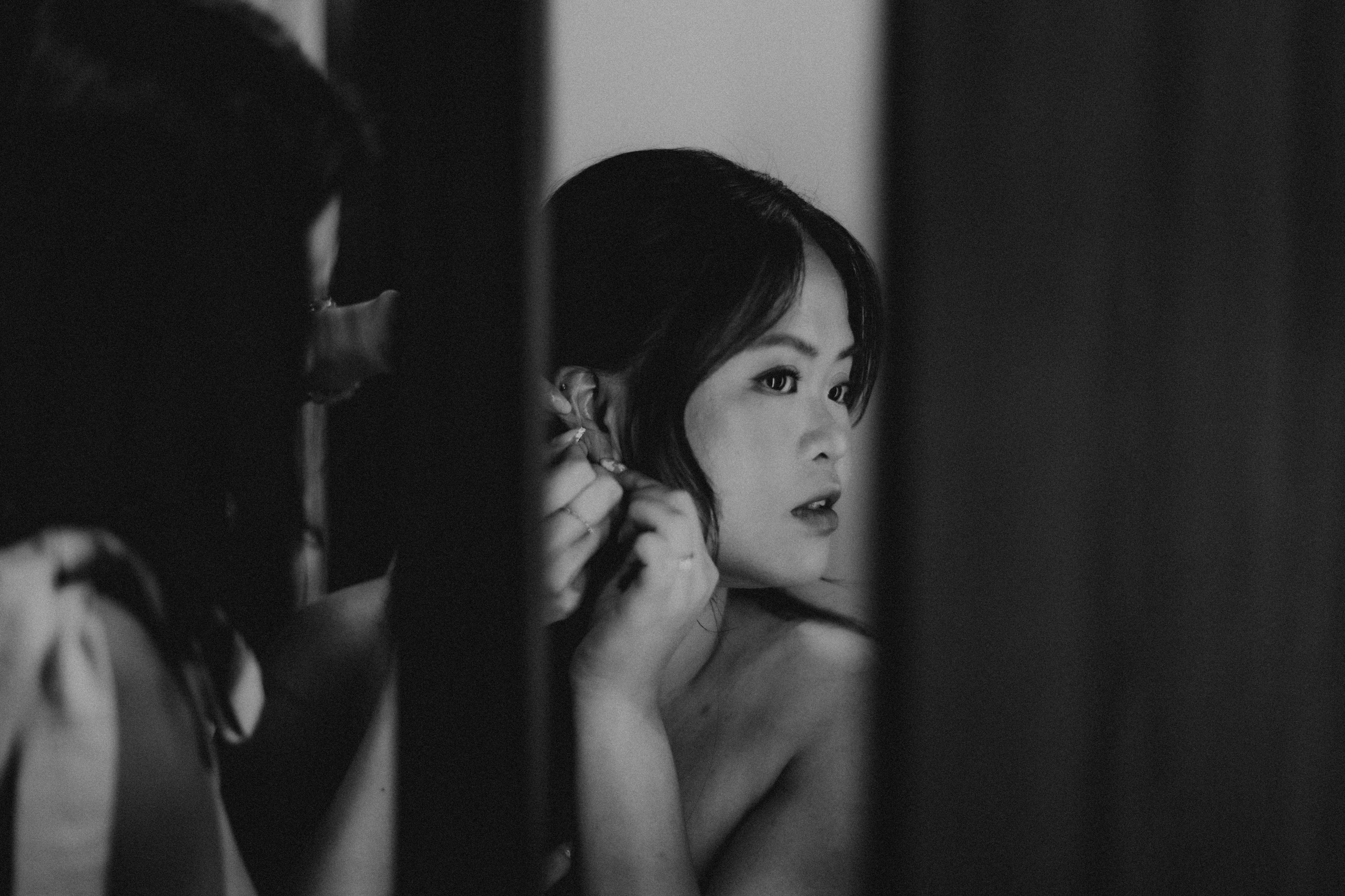 Black and white creative shot of a bride-to-be preparing for her actual day wedding. Photographed by Breadandbutterworks.