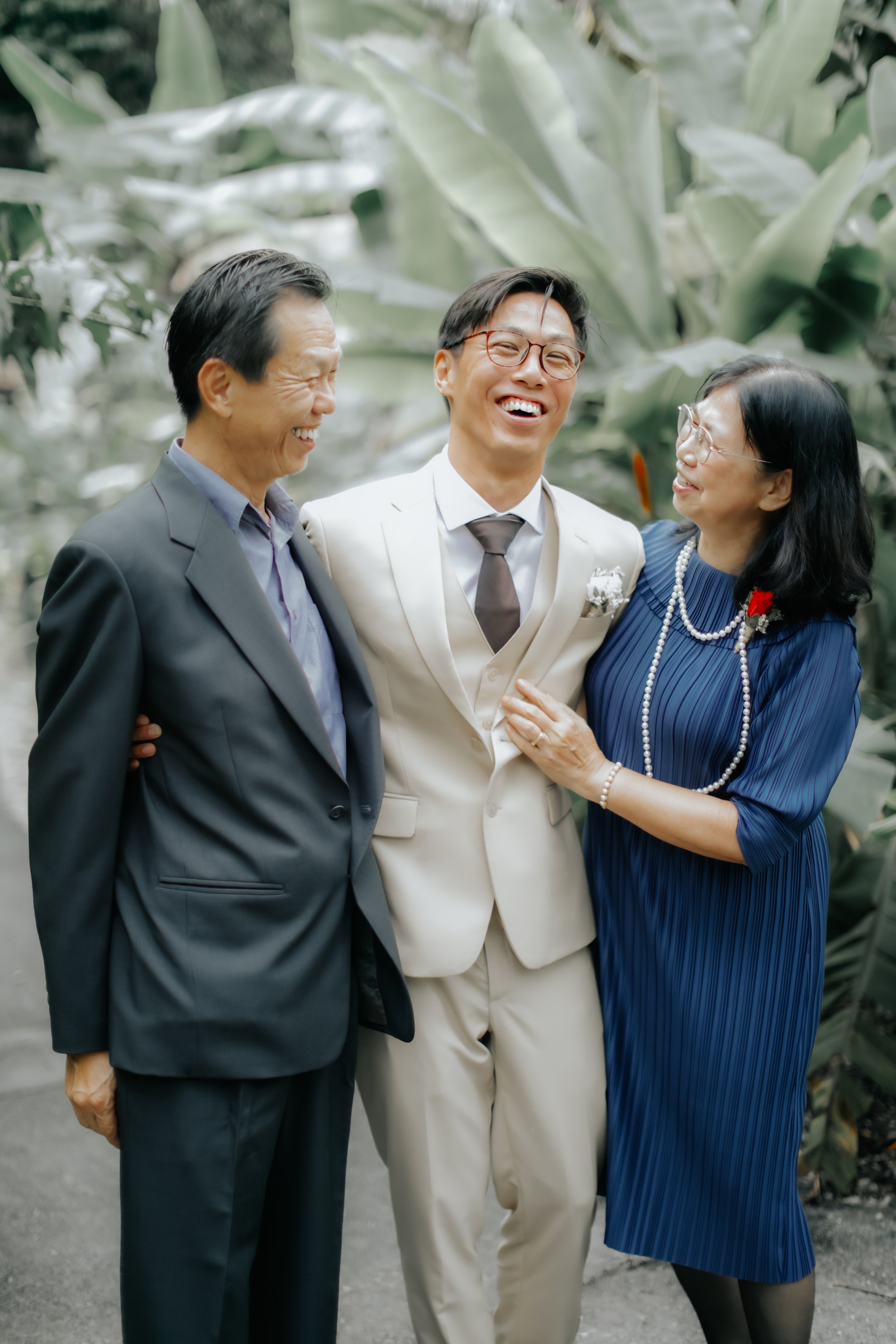 Light and airy actual day wedding photoshoot of the groom and his parents at the wedding venue at The Villa in Singapore. Captured by Arielle for Breadandbutterworks.