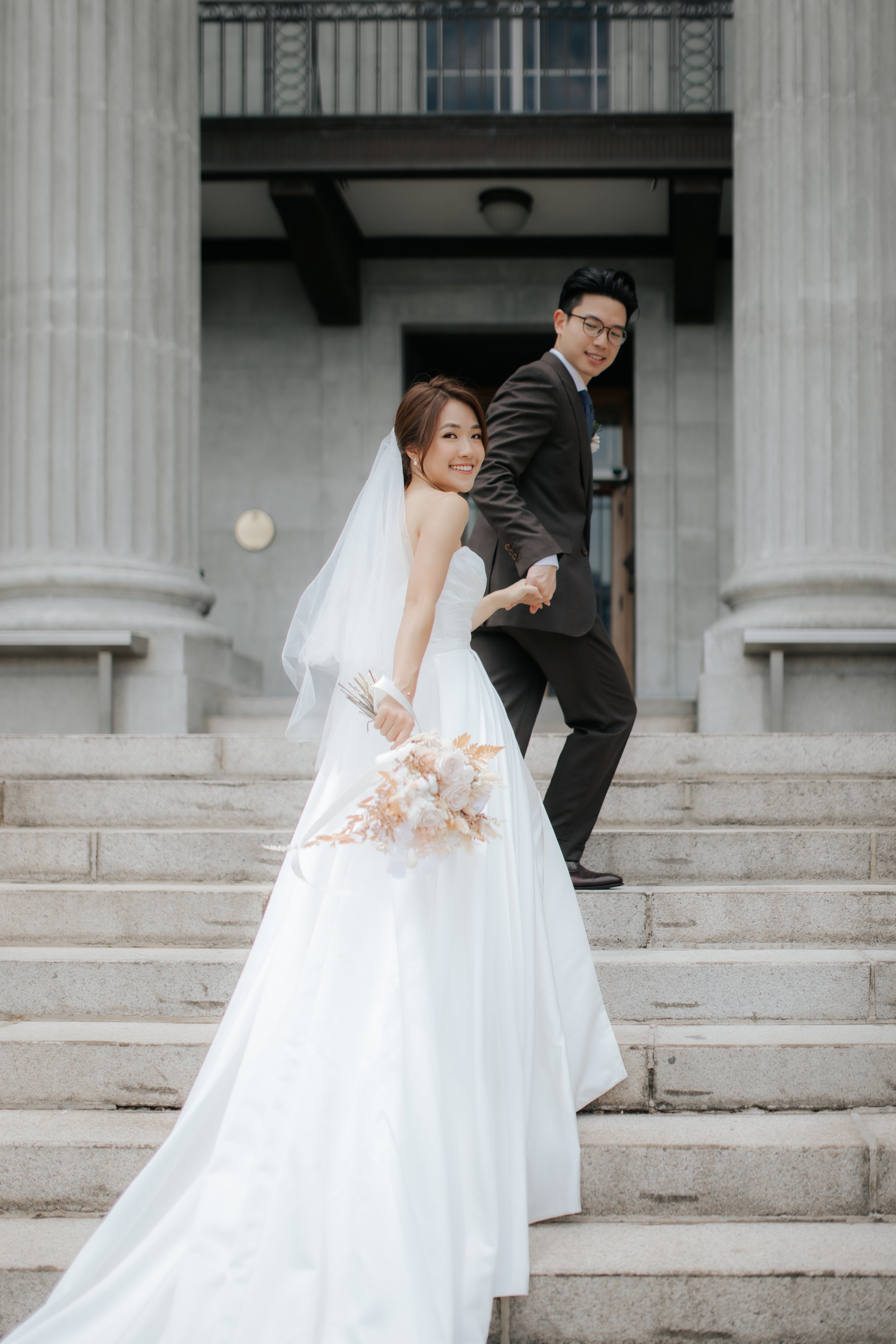 Light and airy actual day wedding photography at Sky Garden Sentosa in Singapore, the couple at the stairway is captured by Ash for Breadandbutterworks.