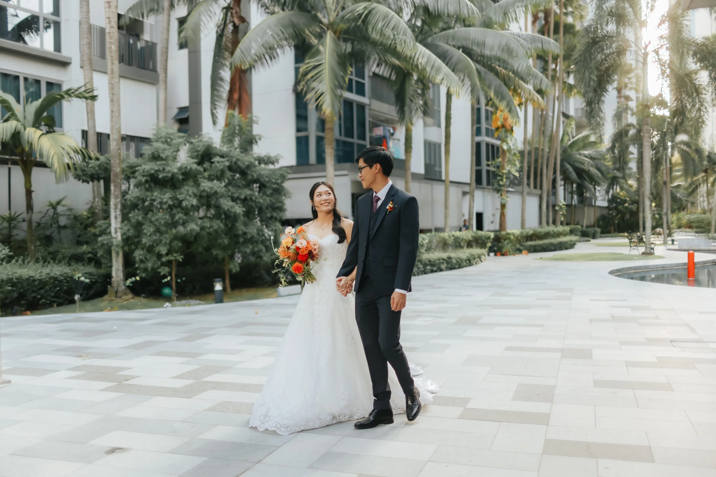 Actual day wedding shoot of a couple posing for a photo at the garden area of their condominium home. Captured in a light and airy style by Arielle for Breadandbutterworks.