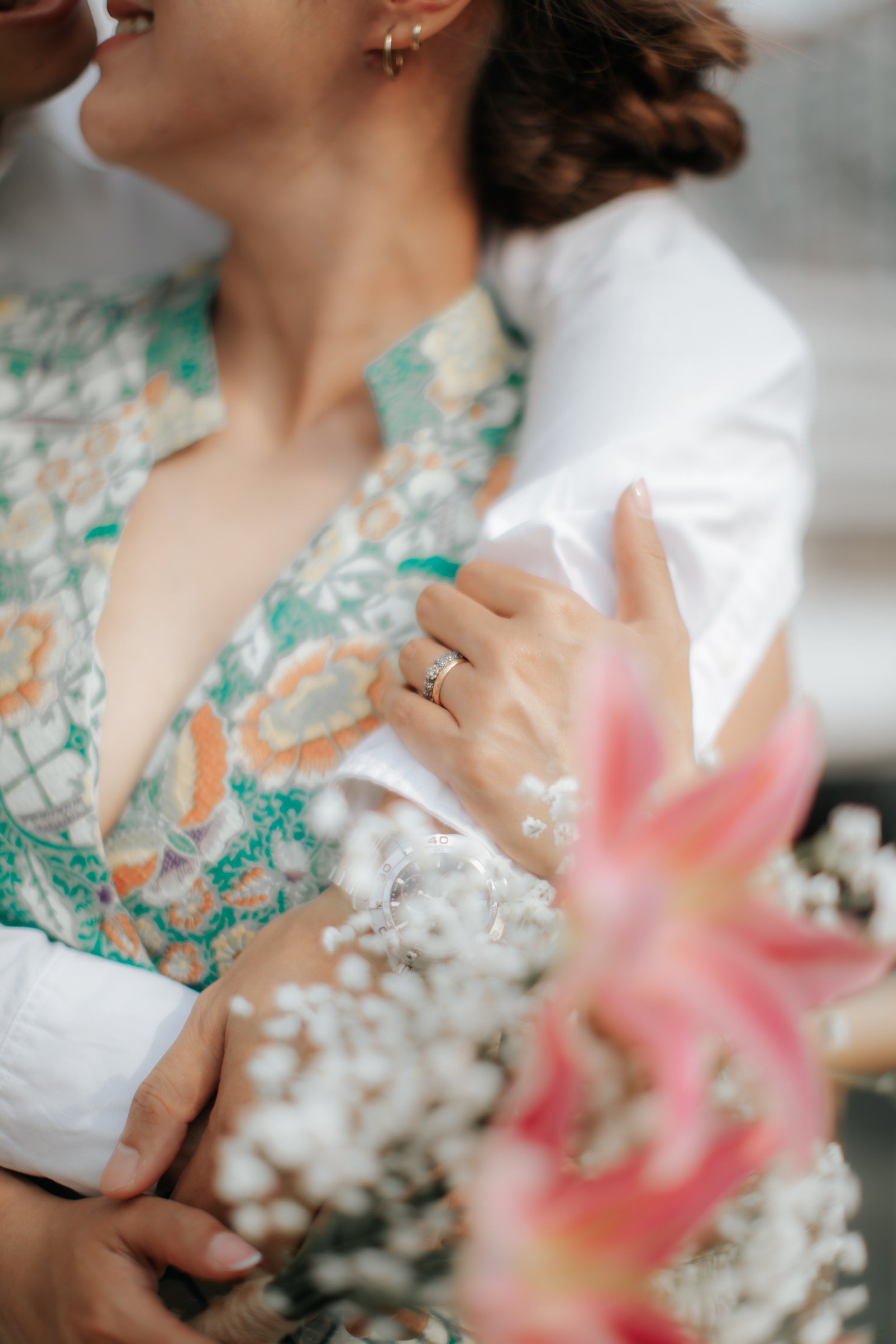 Close-up creative detail photo during a pre-wedding photoshoot of peranakan clothing details and flower bouquet, captured by Ash of Breadandbutterworks.