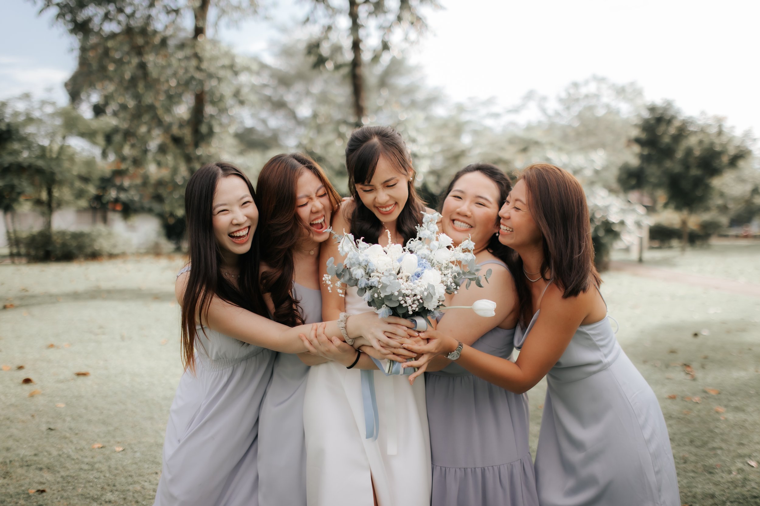 Light and airy actual day wedding photoshoot at Wheeler's Estate and East Coast Park in Singapore of the bride and her bridal party. Captured by Ash for Breadandbutterworks. 