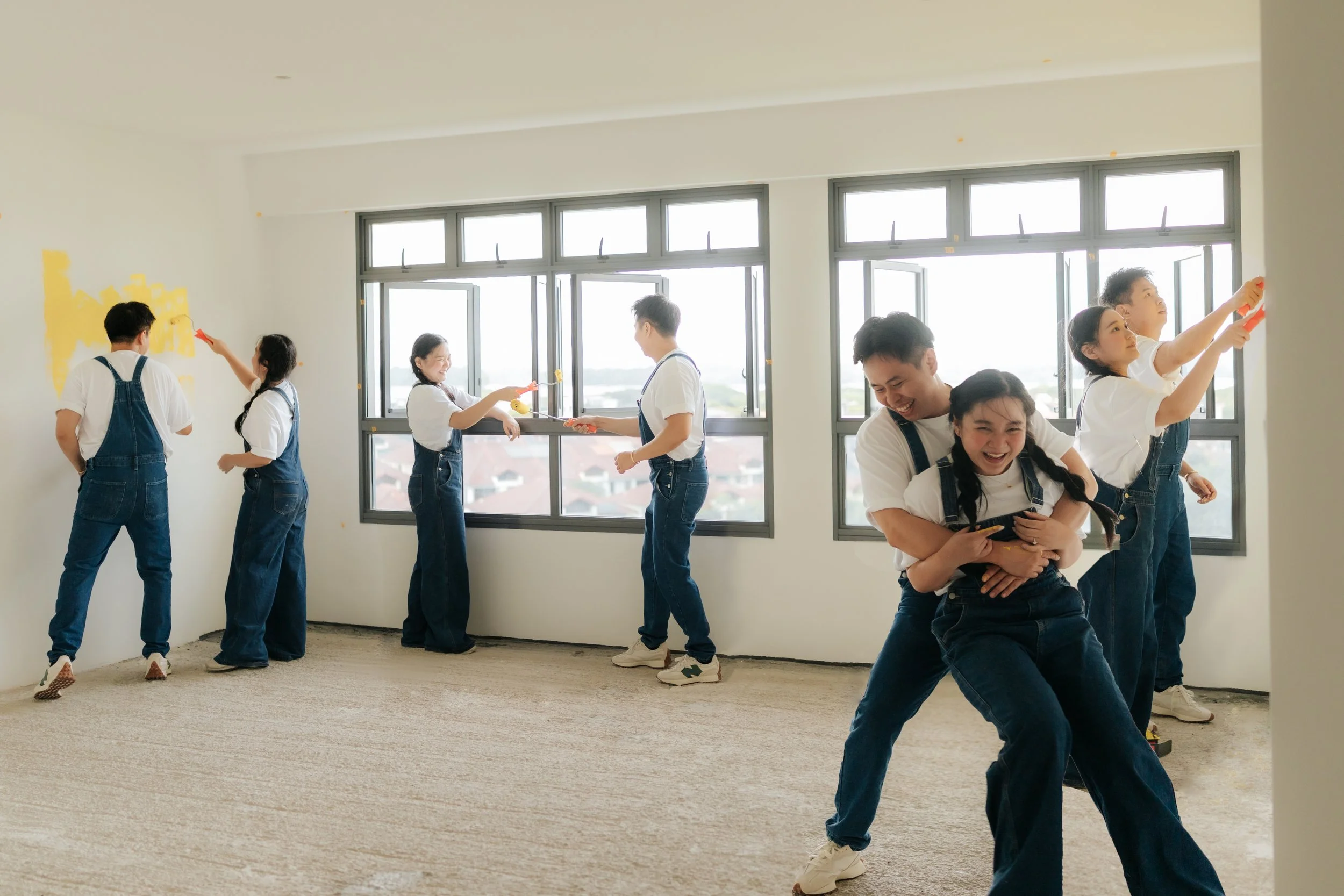 Creative home pre-wedding photo of a couple captured in multiple poses around the same room, showing playful and candid moments by Breadandbutterworks.