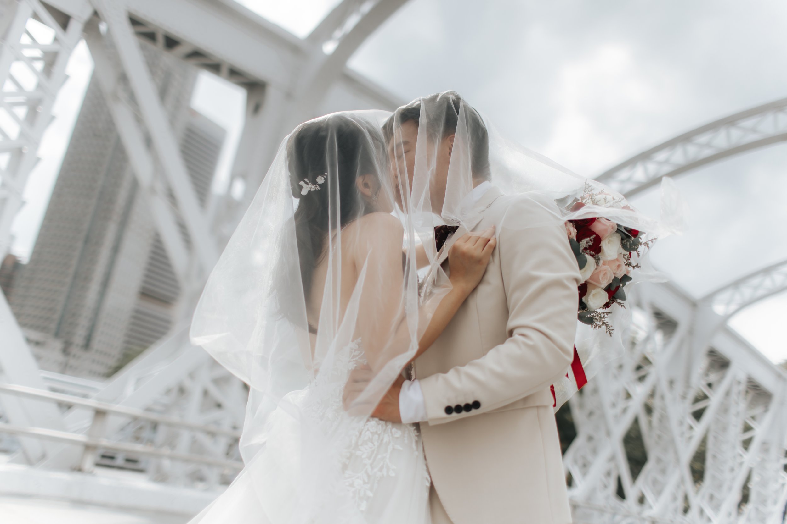 Cover image for Arielle’s pre-wedding photography collection, featuring a couple sharing a romantic moment under a veil in Singapore.