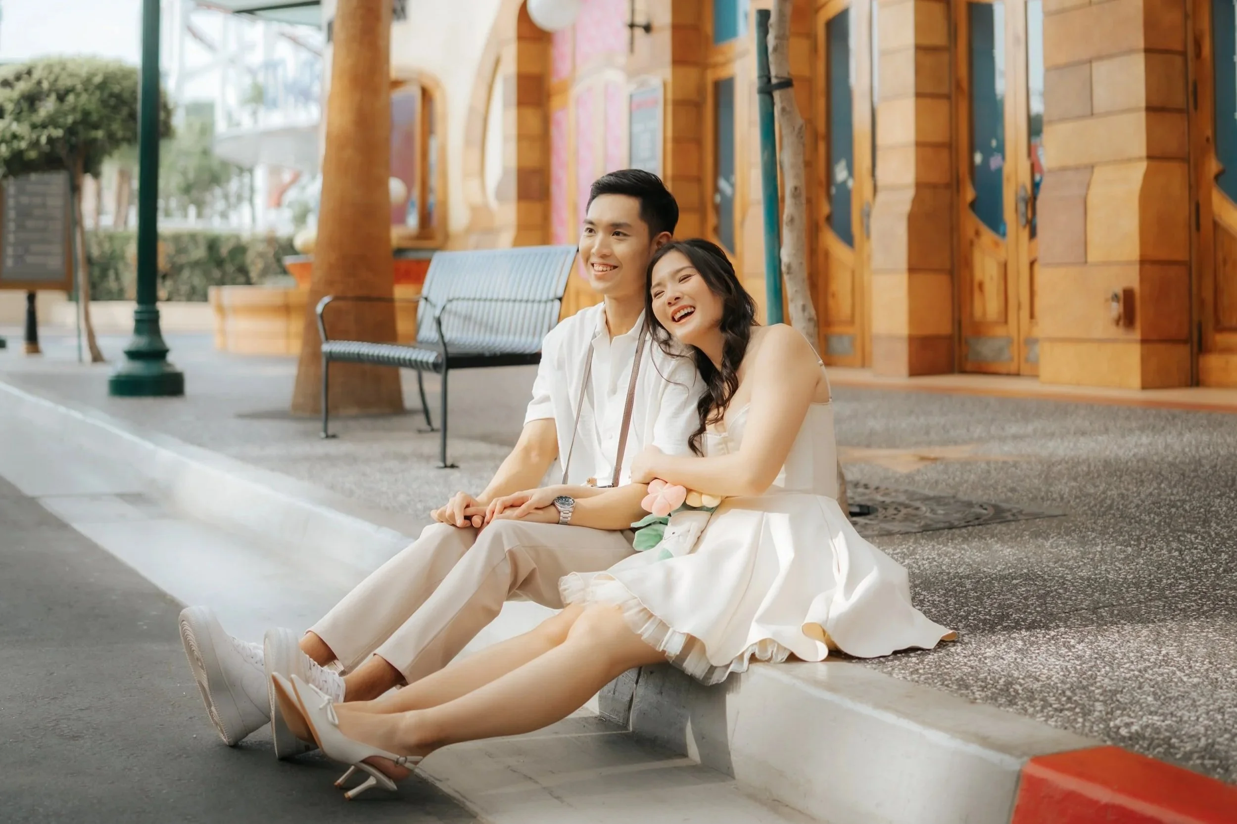 Cover image for Ash’s pre-wedding photography collection, featuring a couple laughing together at Universal Studios Singapore.