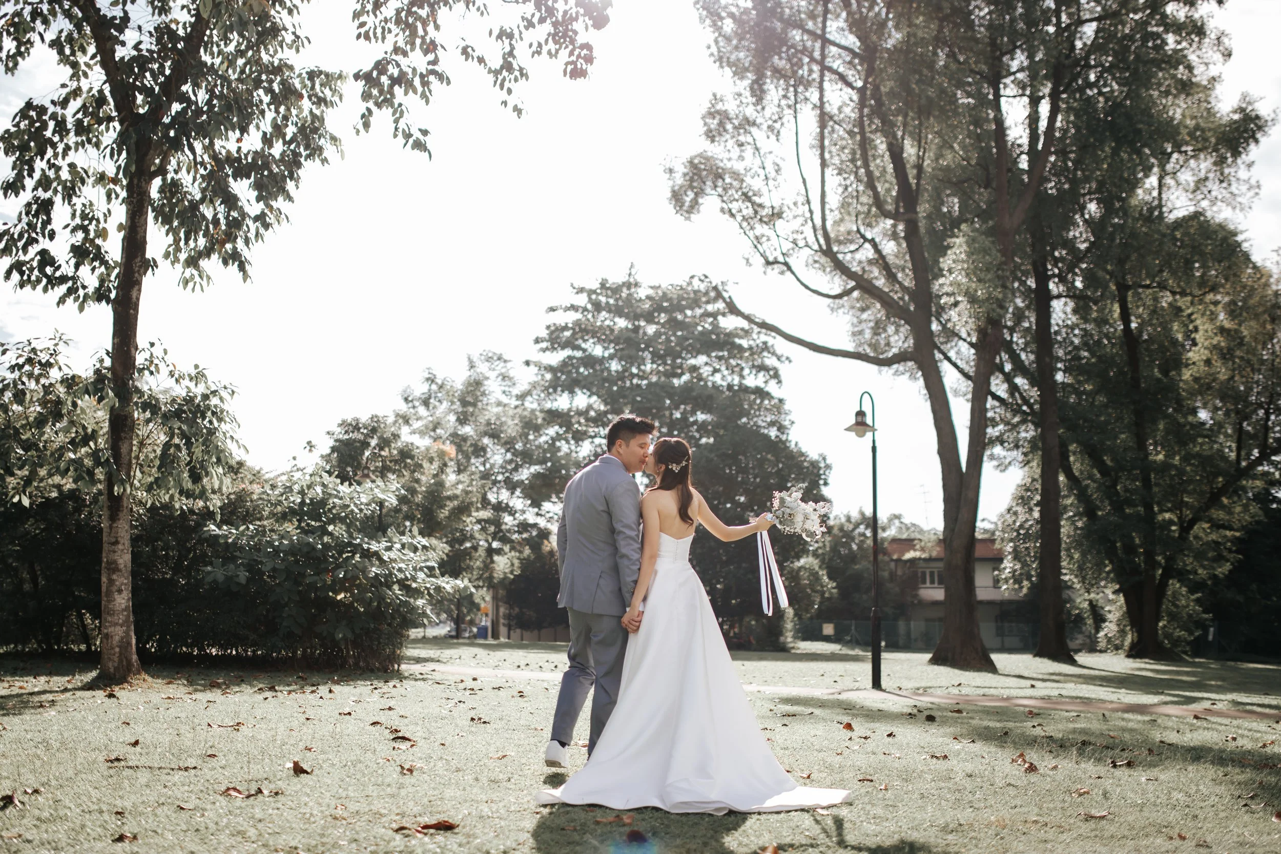 Light and airy actual day wedding photoshoot at Wheeler's Estate and East Coast Park in Singapore. Captured by Ash for Breadandbutterworks. 