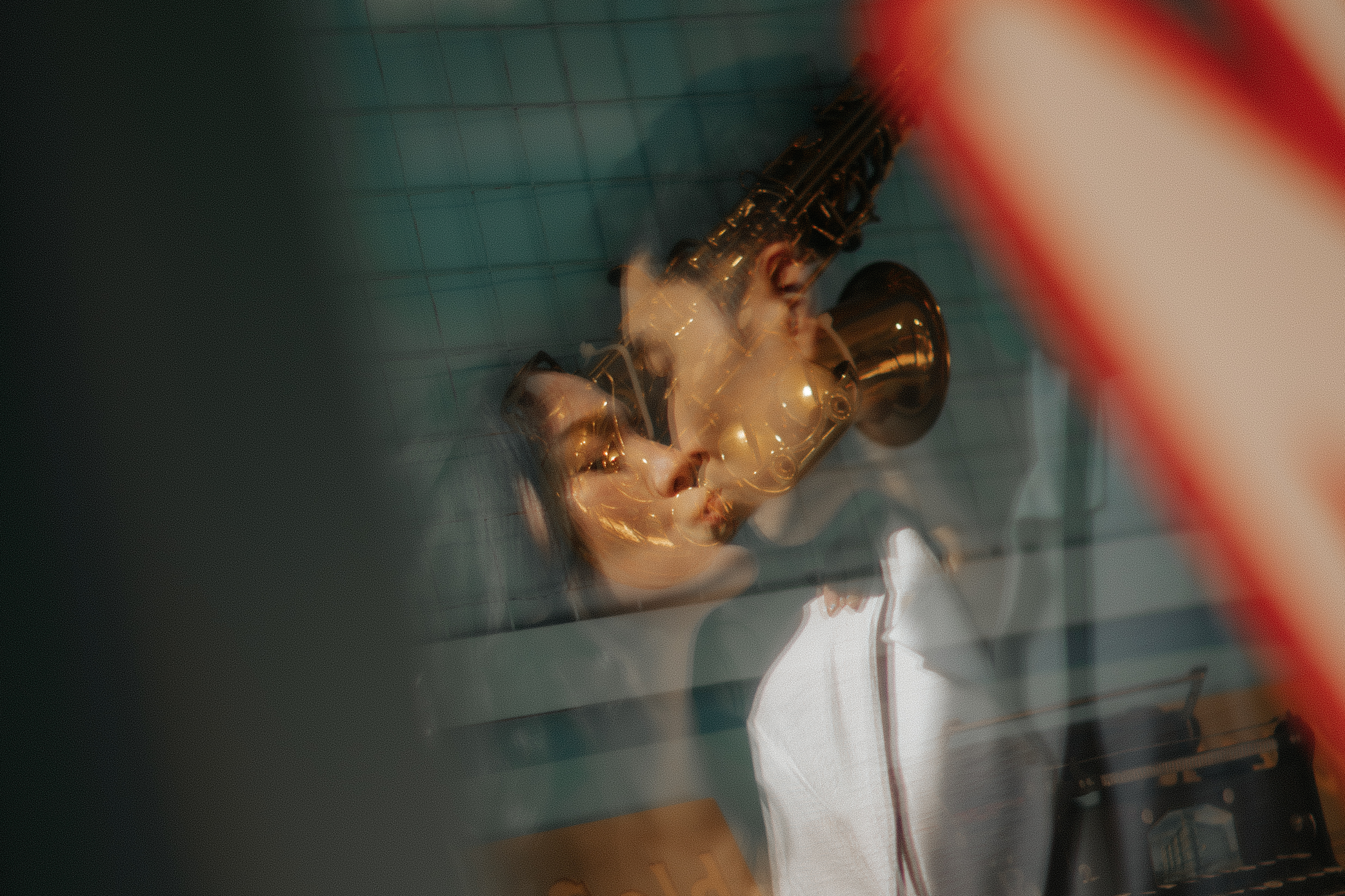 Artistic reflection photo featuring a couple posing for pre-wedding photoshoot in Universal Studios Singapore, captured by Ash for Breadandbutterworks.
