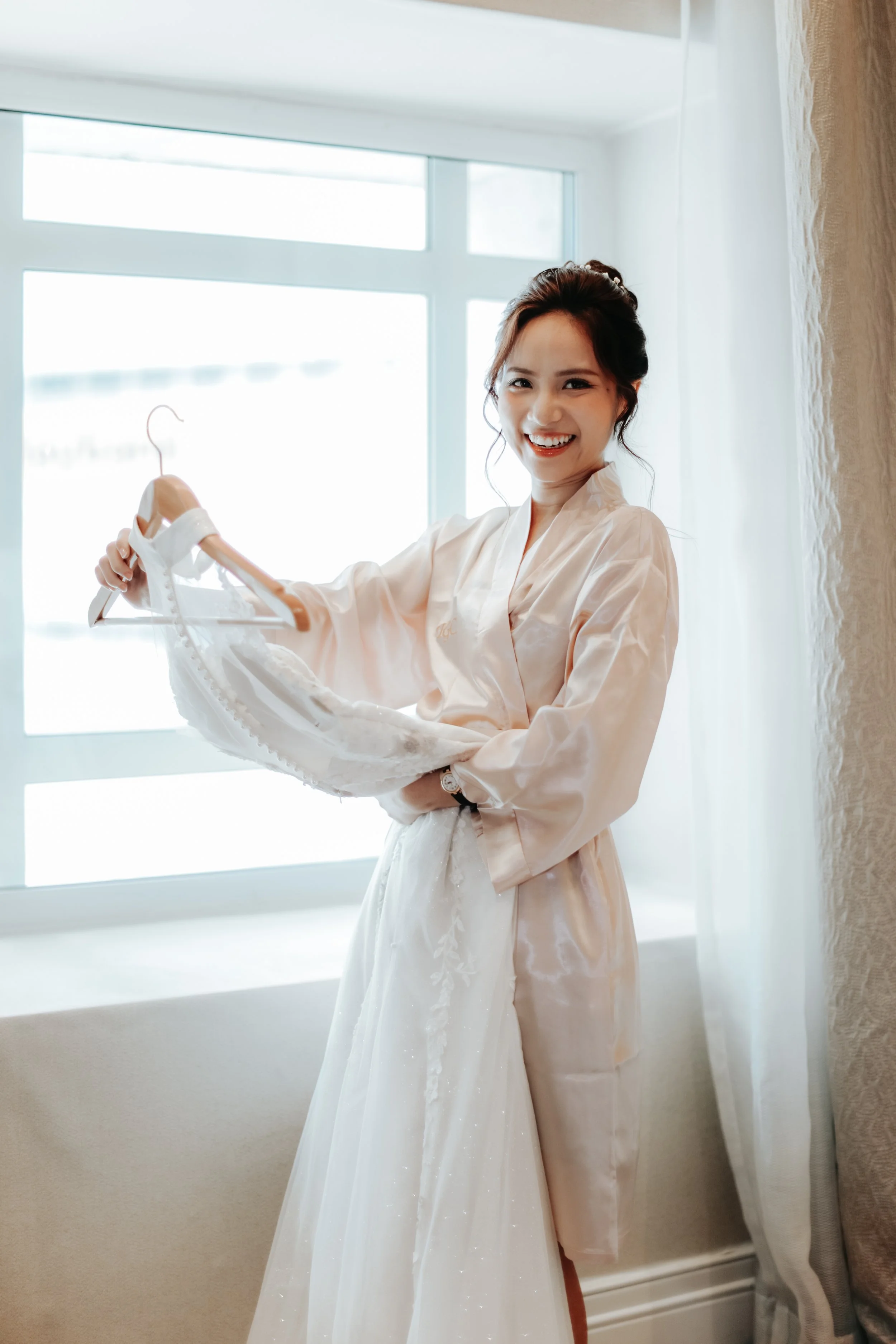 Light and airy actual day wedding photoshoot of the bride-to-be getting ready with her wedding gown. Captured by Arielle for Breadandbutterworks.
