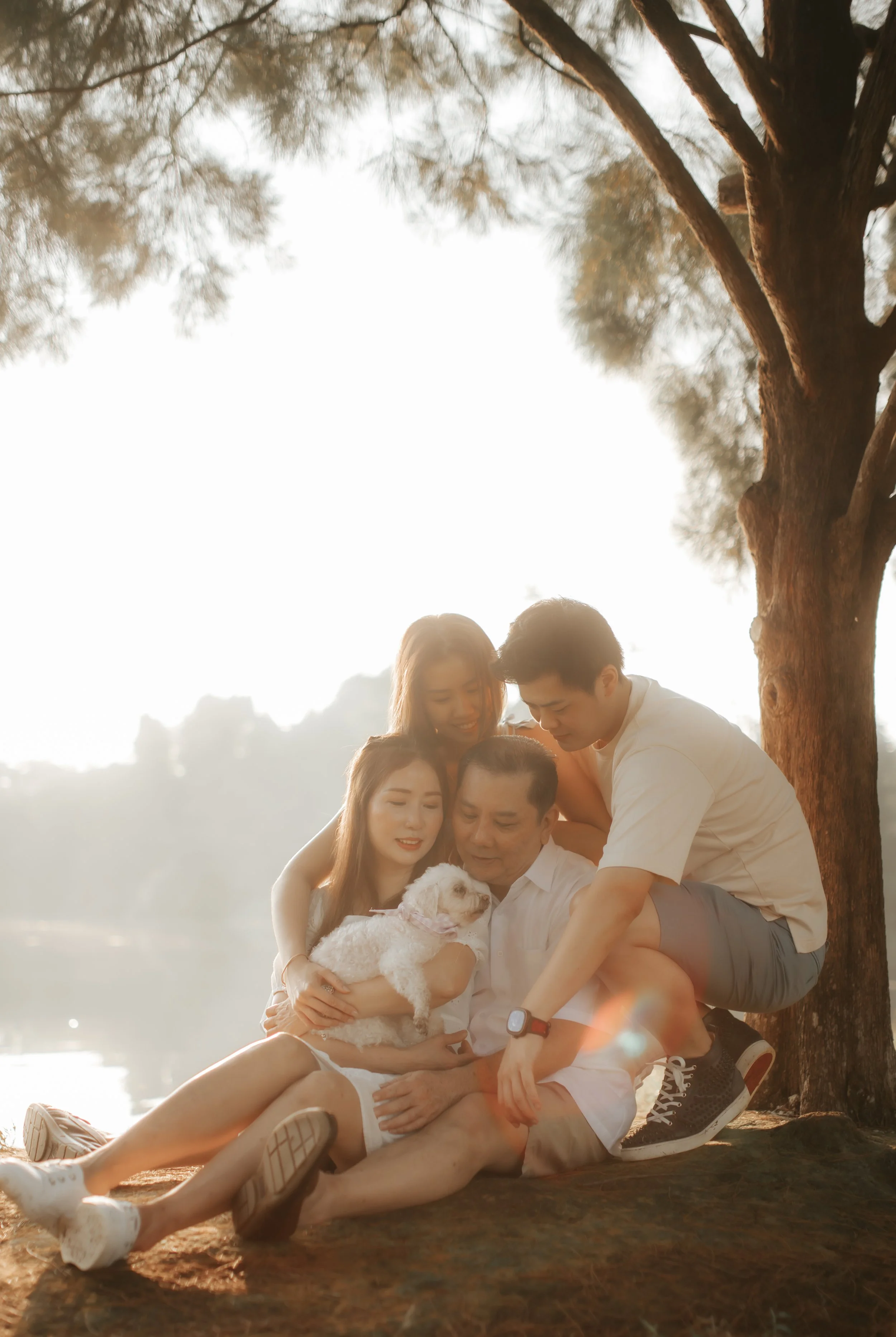 Warm and intimate family photoshoot with the family pet dog, captured by Breadandbutterworks in a soft and heartfelt style.