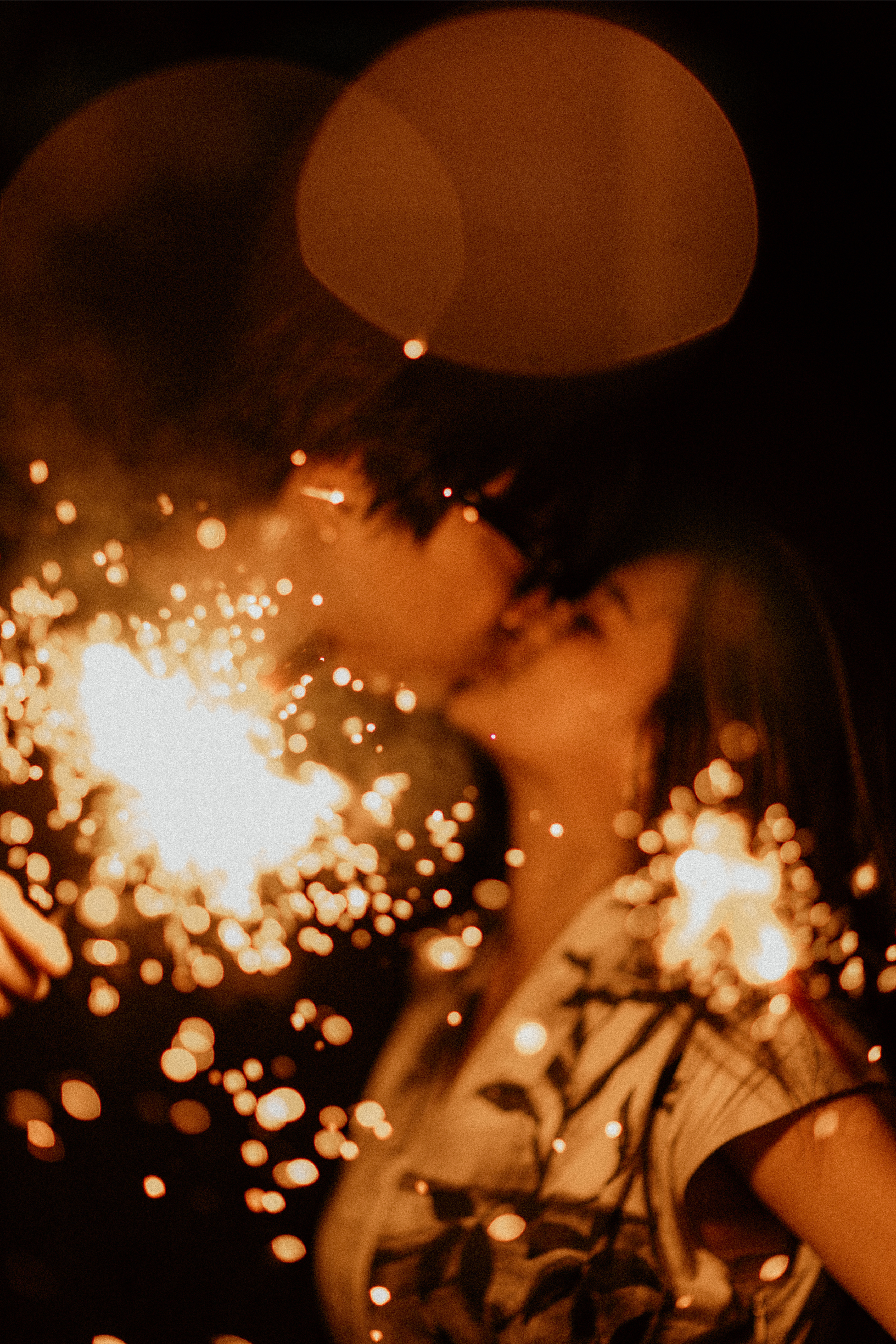 Cinematic night pre-wedding photo featuring sparklers and dramatic light of a couple, captured by Breadandbutterworks in a soft and heartfelt style.