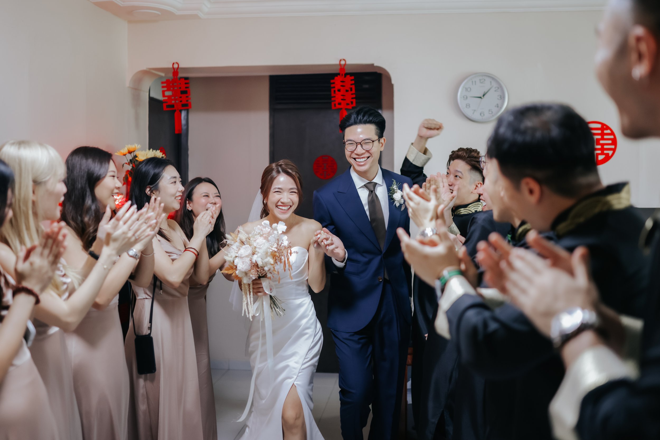Light and airy actual day wedding photoshoot with the bridesmaids and groomsmen cheering them on as they walk on. Captured by Ash for Breadandbutterworks.