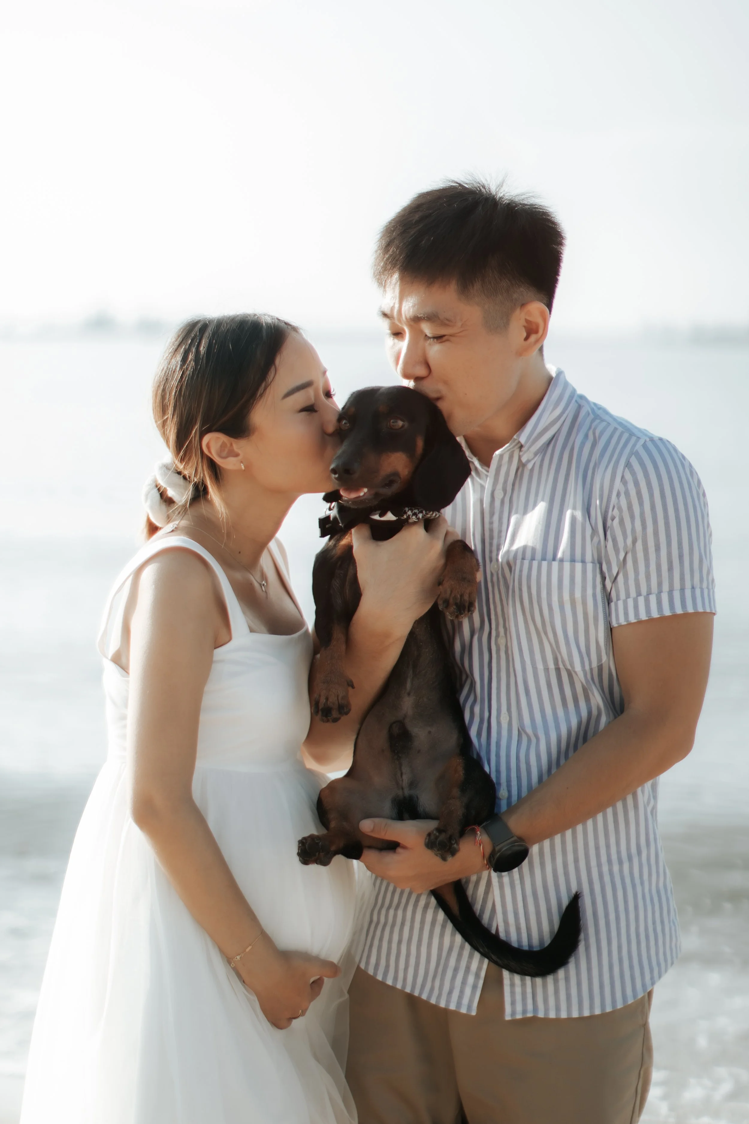 Light and airy maternity beach photoshoot at East Coast Park with a pet dog, captured by Arielle for Breadandbutterworks.